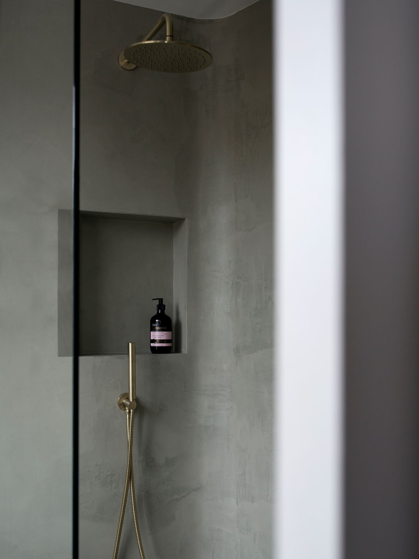 Brass accents, which feature throughout the home, can be found in the bathroom as well
