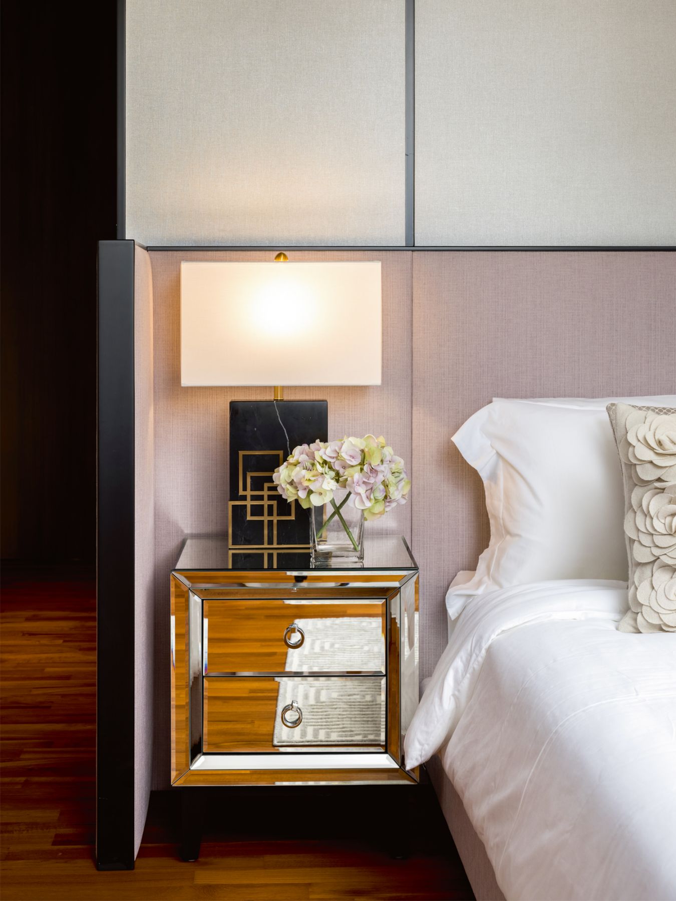 A custom-made headboard creates a cocooning feel in the grandmother’s room
