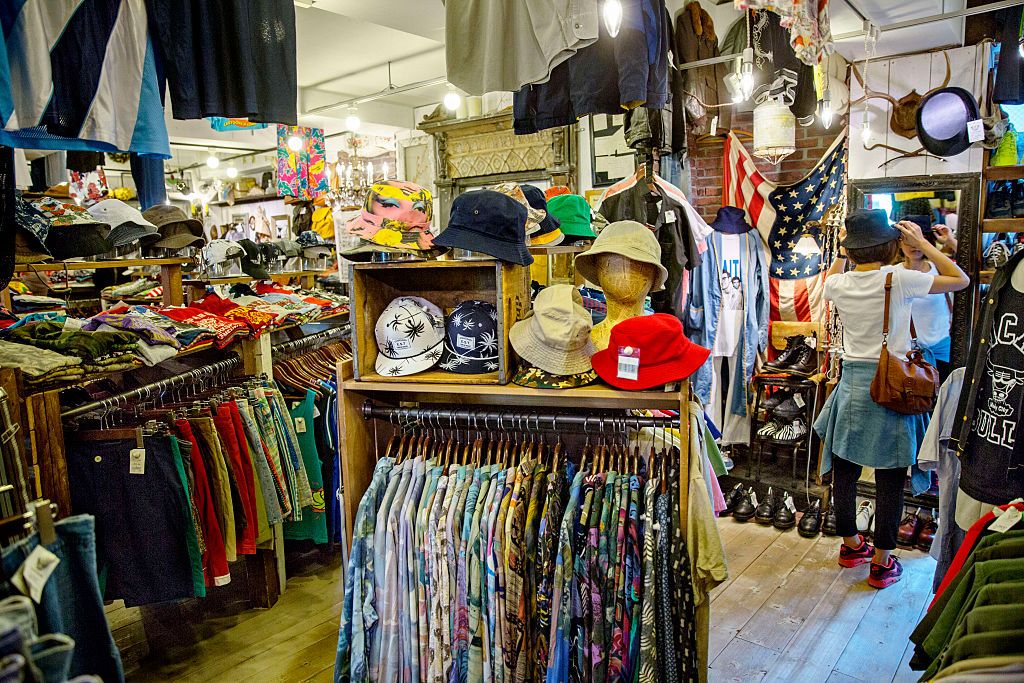 HARAJUKU, TOKYO, JAPAN - 2015/08/03: A women is looking at second hand clothing at a second hand shop in Tokyo- Japan. (Photo by Jonas Gratzer/LightRocket via Getty Images)