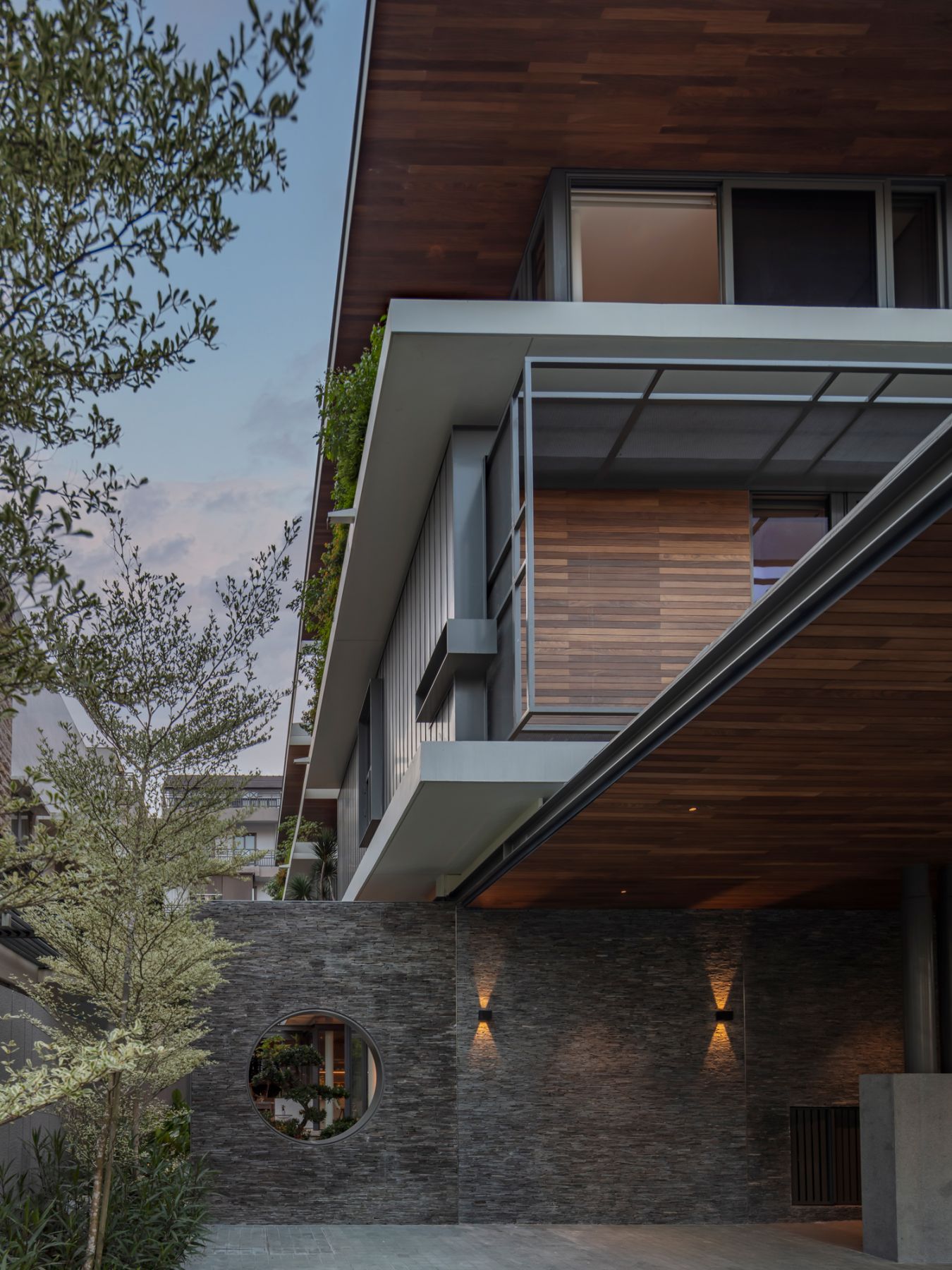 The round moon window, which can be seen both from the exterior and interior of the home, adds a touch of Japanese element to the home