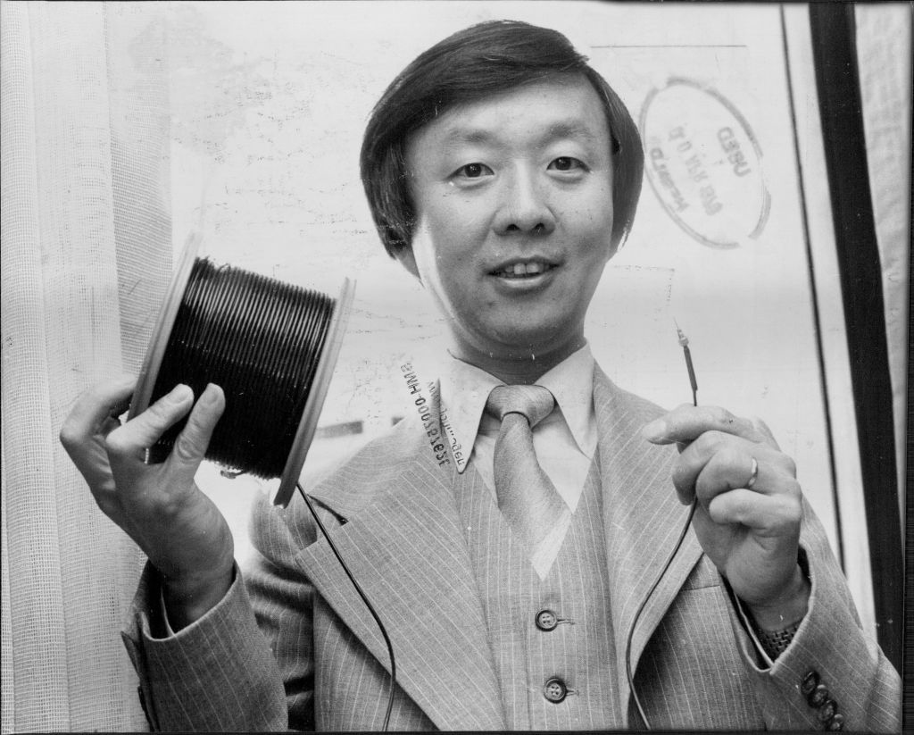 American Scientist Dr. Charles Kao who invented optical fibre communication, Photographed in his Hilton Hotel suite, with single-fibre-optical cable with connector, which is able to take hundreds of phone calls and TV transmission. April 09, 1978. (Photo by Antonin Cermak/Fairfax Media via Getty Images).
