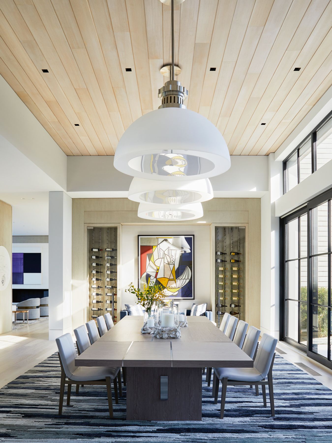 A vibrant painting by Mexican artist Jose Dávila takes centrestage in the dining room, which also features Fontana Arte Avico suspension lamps, a rug from Scott Group Studio and a dining table and chairs designed by Pembrooke & Ives