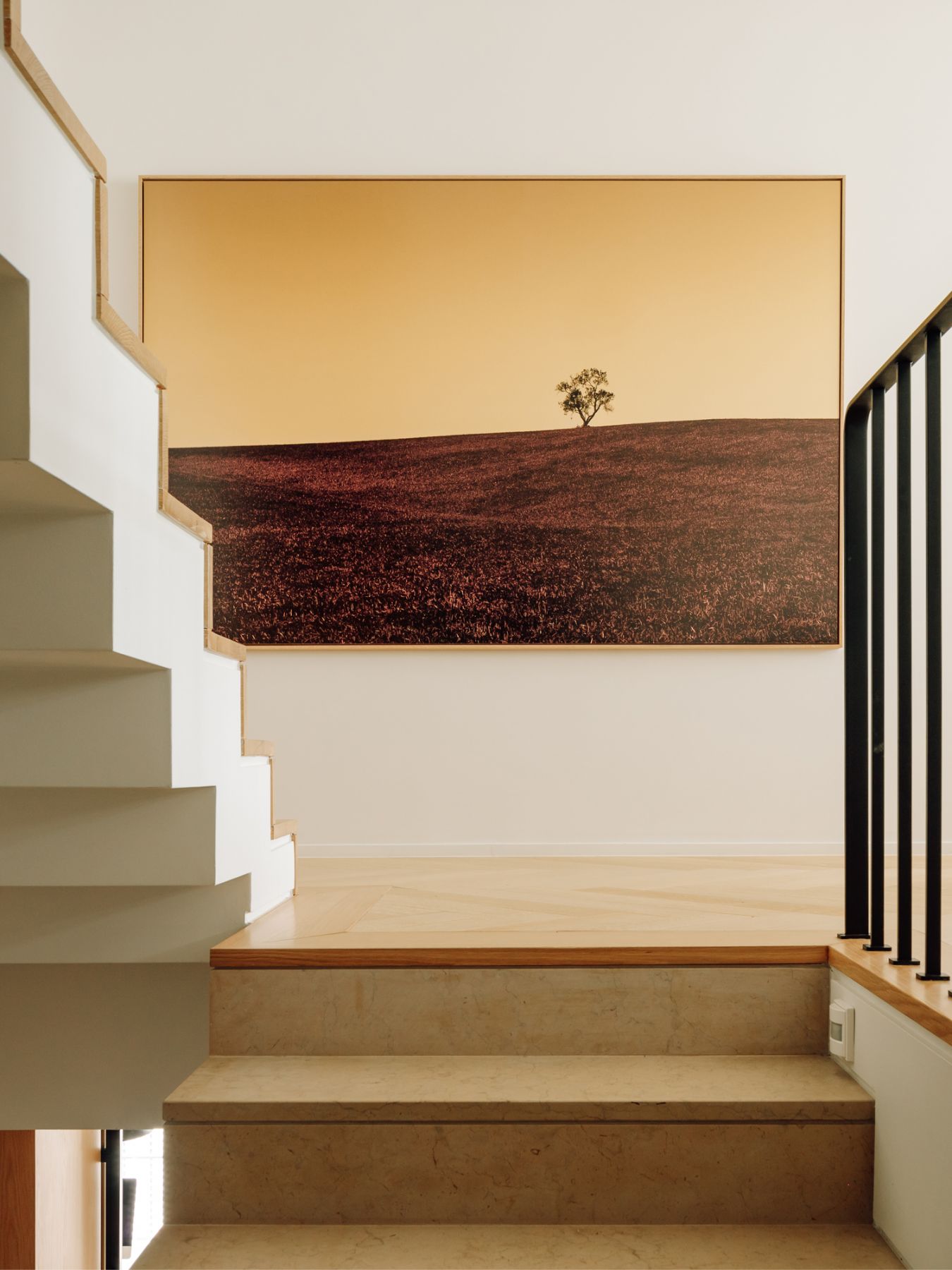 A photo from Spanish photographer Humberto Ybarra greets guests at the staircase on the first floor