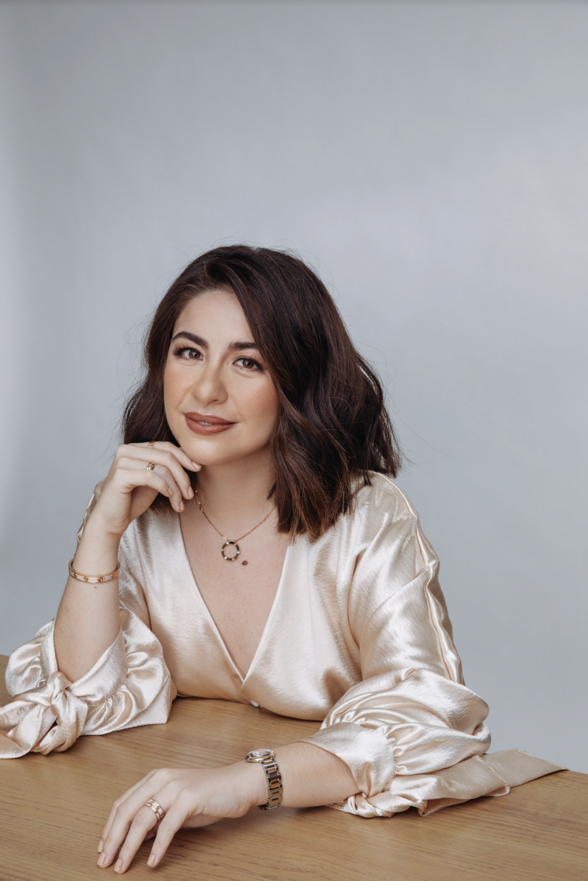 Vania Romoff in Cartier Love bracelet, necklace and ring, Trinity rings and Ballon Bleu de Cartier