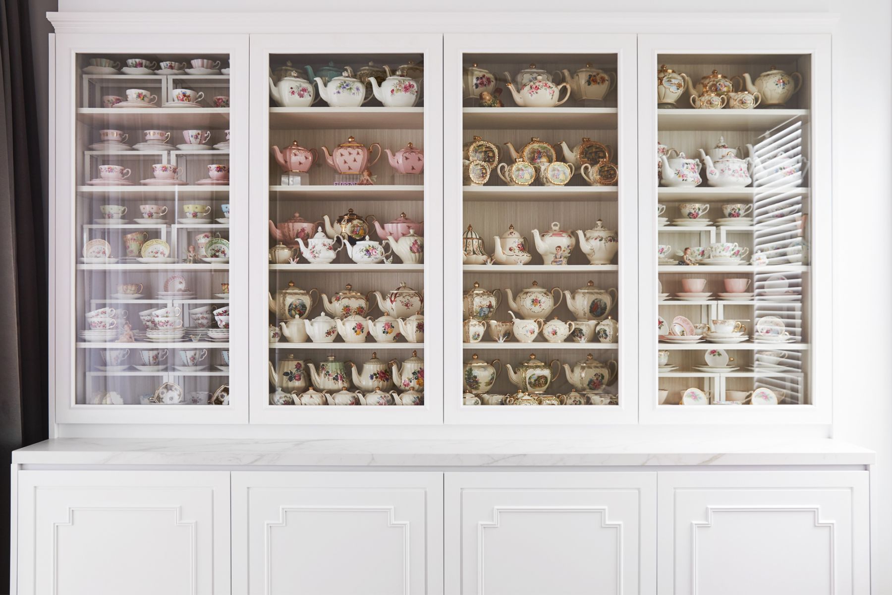 The off-white cabinetry was specially built to house her treasured collection