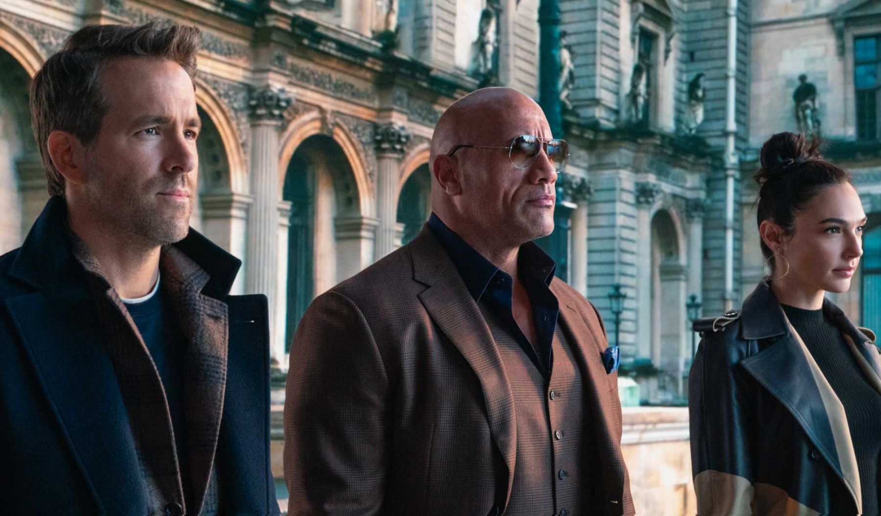 RED NOTICE - (L-R) RYAN REYNOLDS, DWAYNE âTHE ROCKâ JOHNSON, and GAL GADOT STAR IN NETFLIXâS RED NOTICE RELEASING NOVEMBER 12, 2021. WRITTEN & DIRECTED BY RAWSON MARSHALL THURBER. Cr: Frank Masi/NETFLIX © 2021