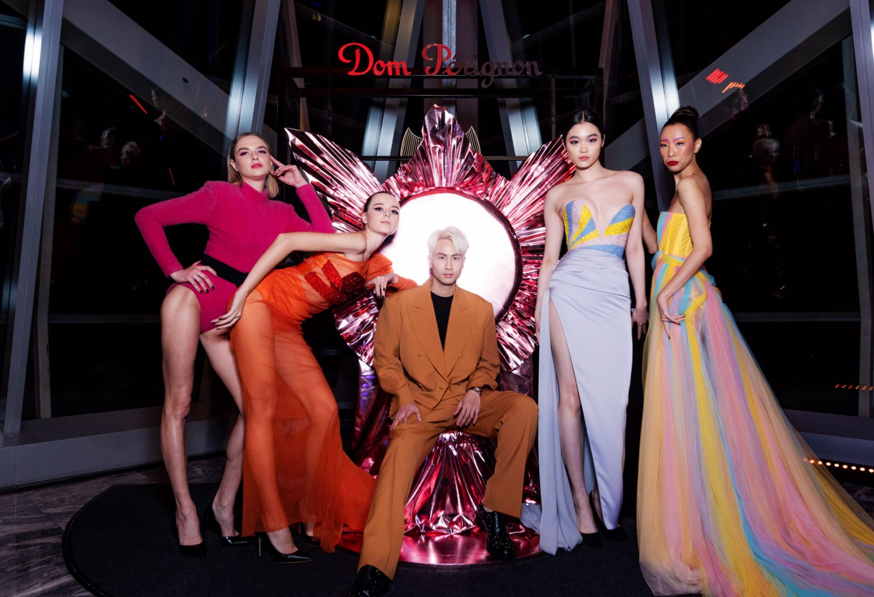 Designer Brian Khoo next to the models showcasing his avant-garde fashion collection