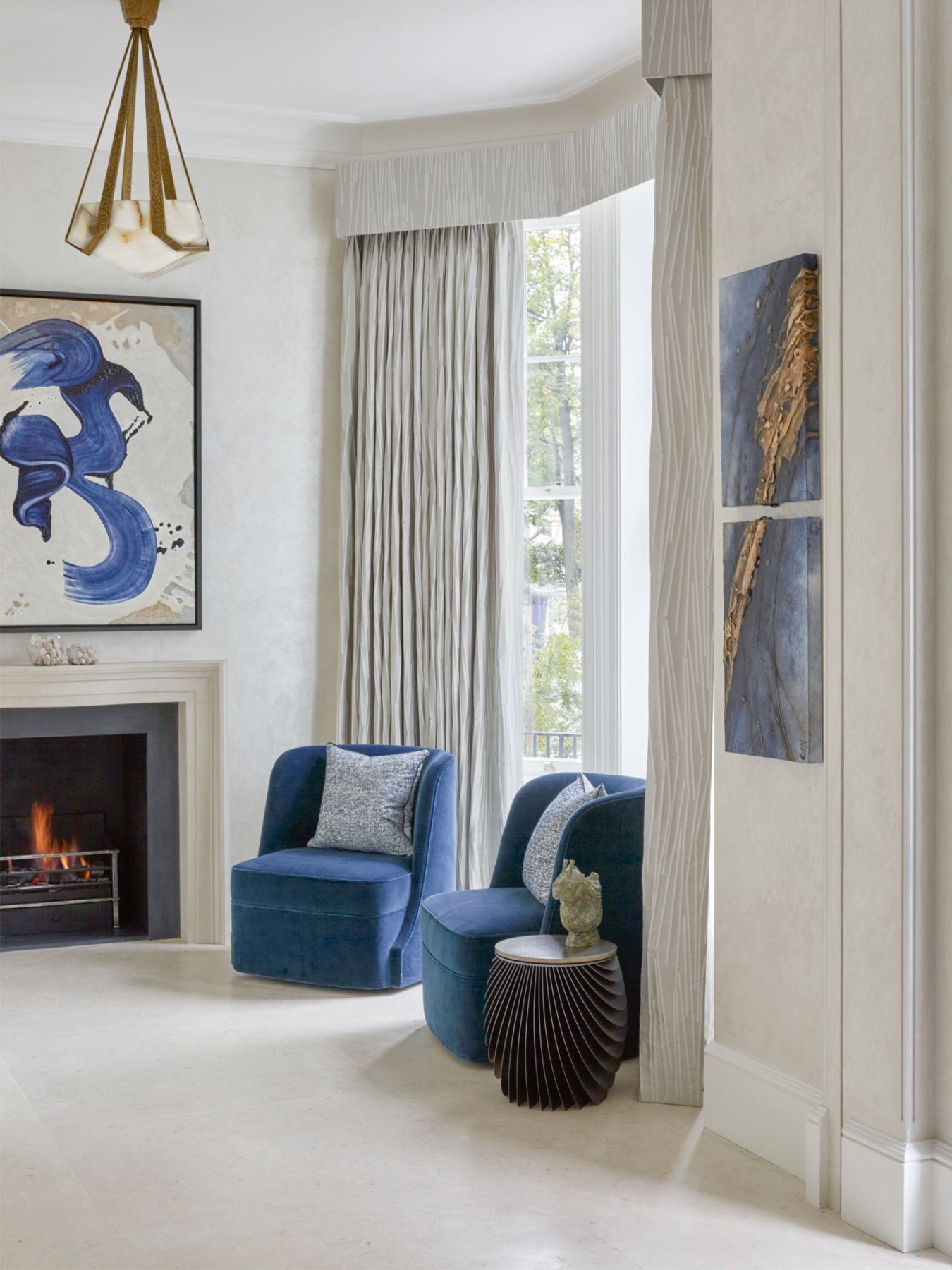 A subtle embroidered edge on the curtains adds detail to the drawing room