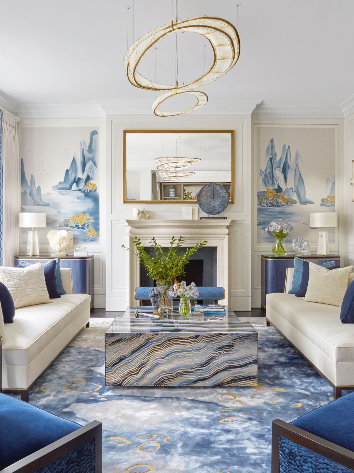 hand-painted Fromental wallpaper panels echo the use of blue tones in the drawing room