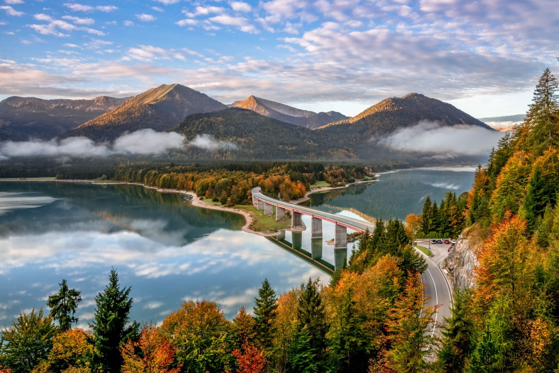 Sylvenstein Lake and bridge surrounded by the morning mist. Bad Tölz-Wolfratshausen district, Bavaria, Germany.