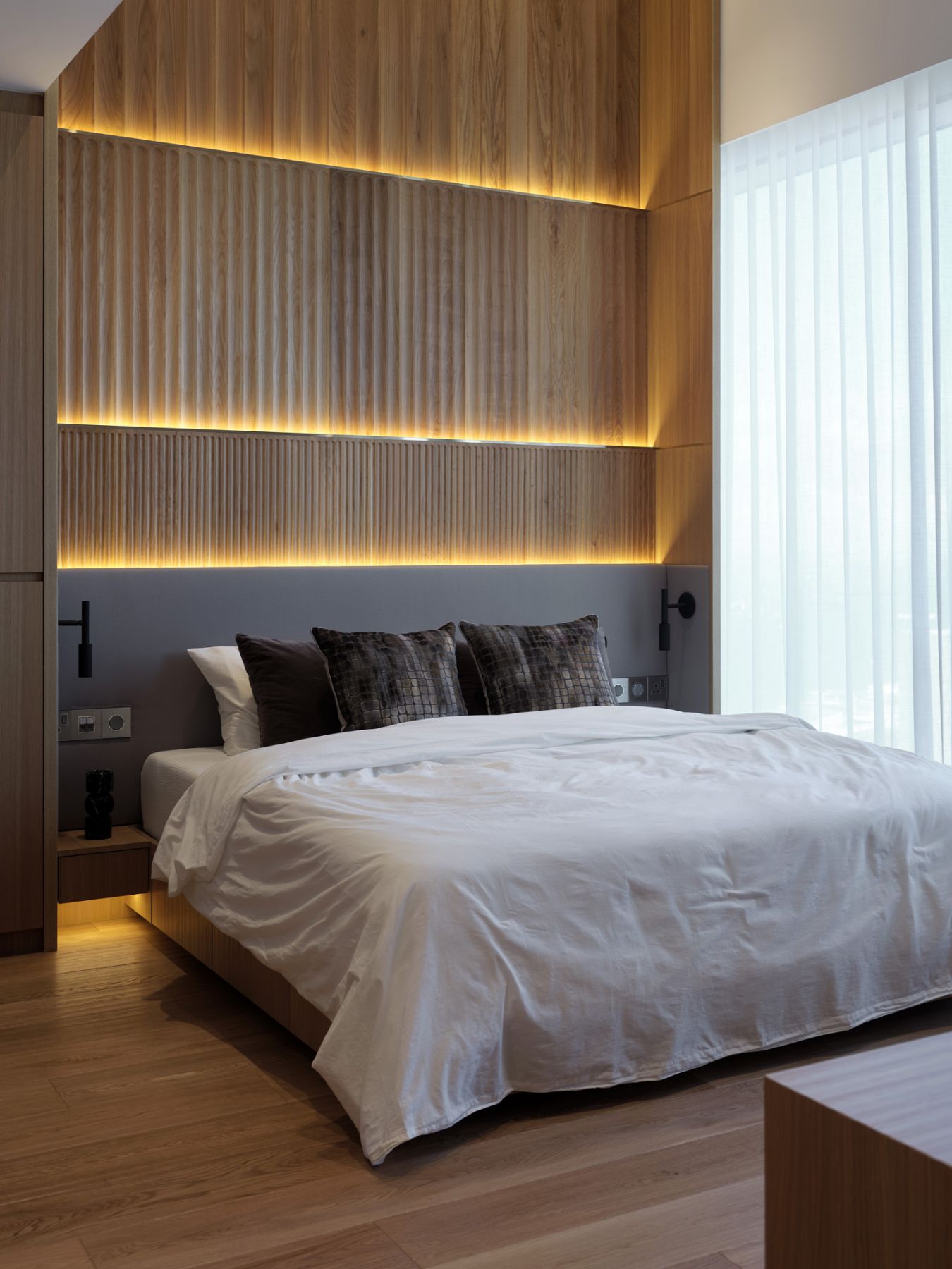 The master bedroom exudes tranquility with timber panelling that references Japanese style aesthetics
