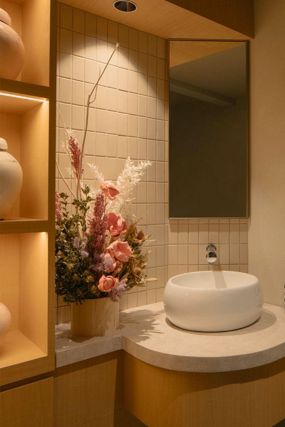 The bathroom is brightened up with a bouquet of blooms (Image: Courtesy of Khoo Guo Jie)