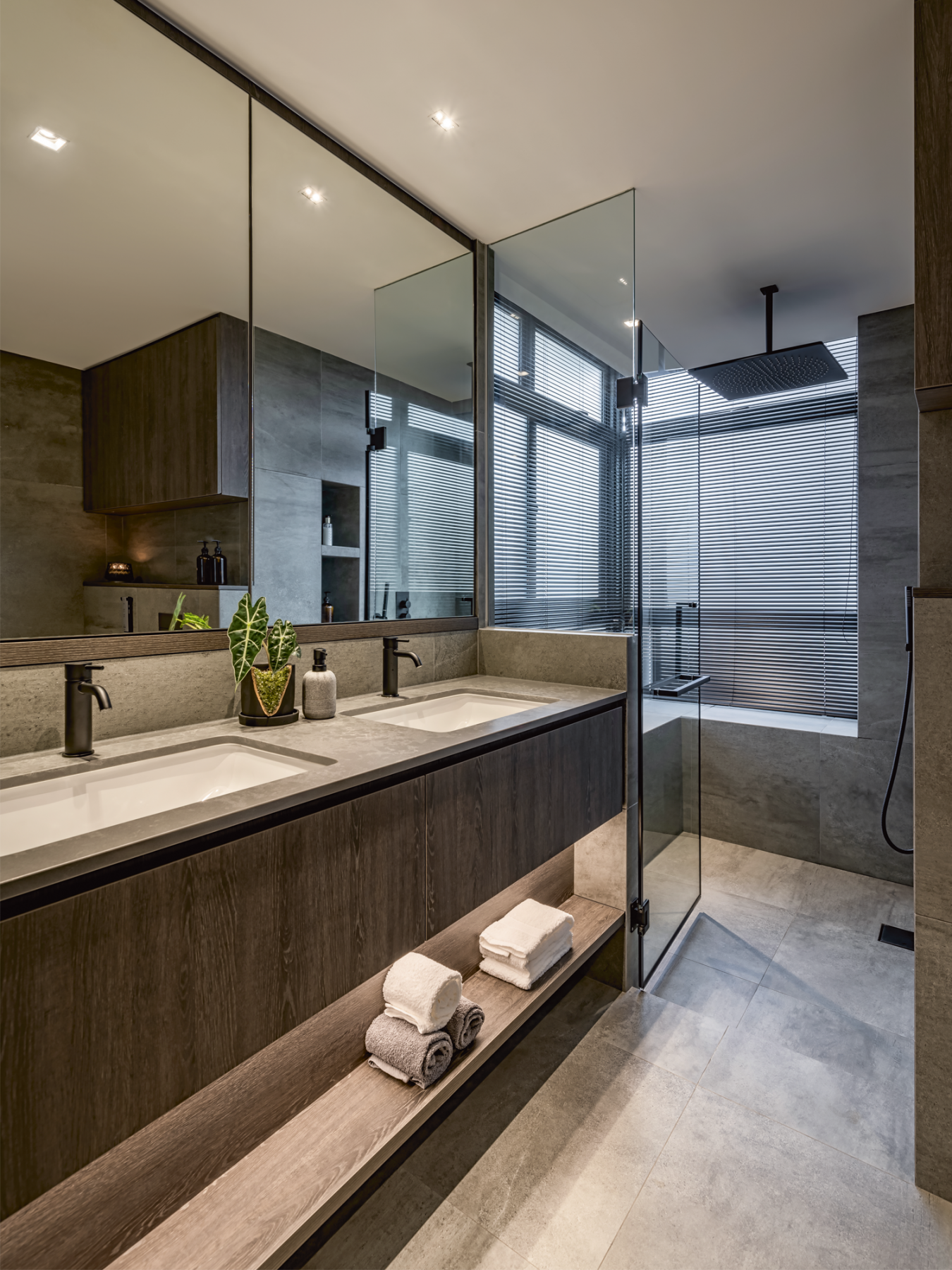 The master bathroom is an elegant space clad in a mix of dark wood and stone