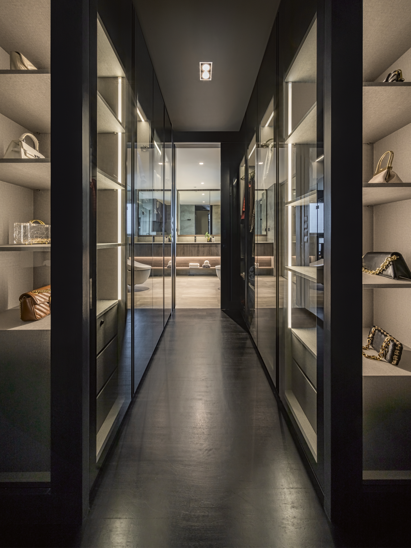 This stunning walk-in wardrobe features full-length display shelves in a boutique-like setting