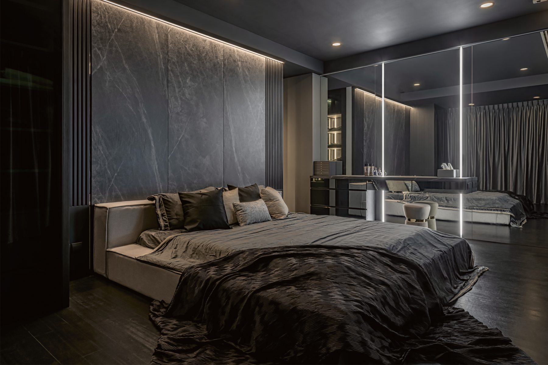 The master bedroom’s dark material and colour palette create a luxurious ambience inspired by hotel suites
