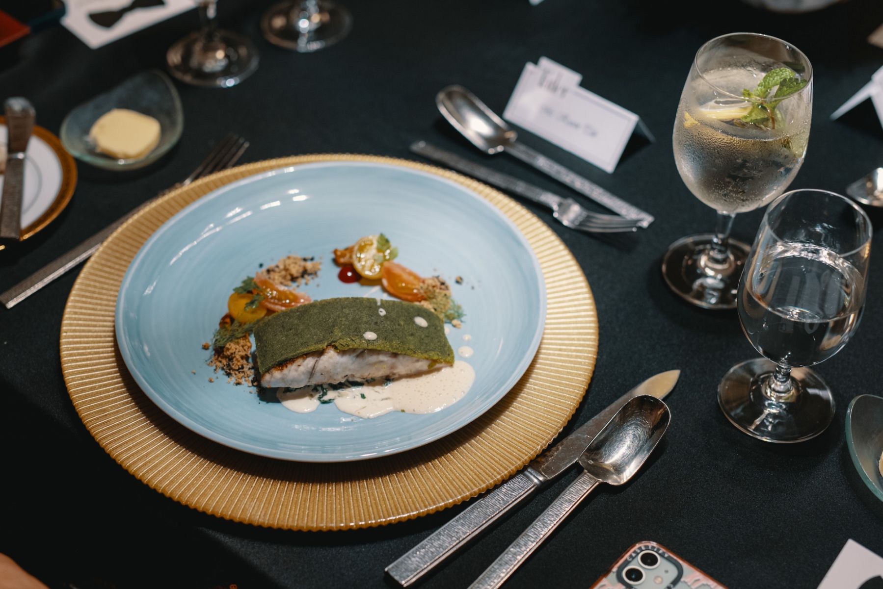 Seabass with Provencal crust, creamy spinach, cherry tomato confite and champagne sauce
