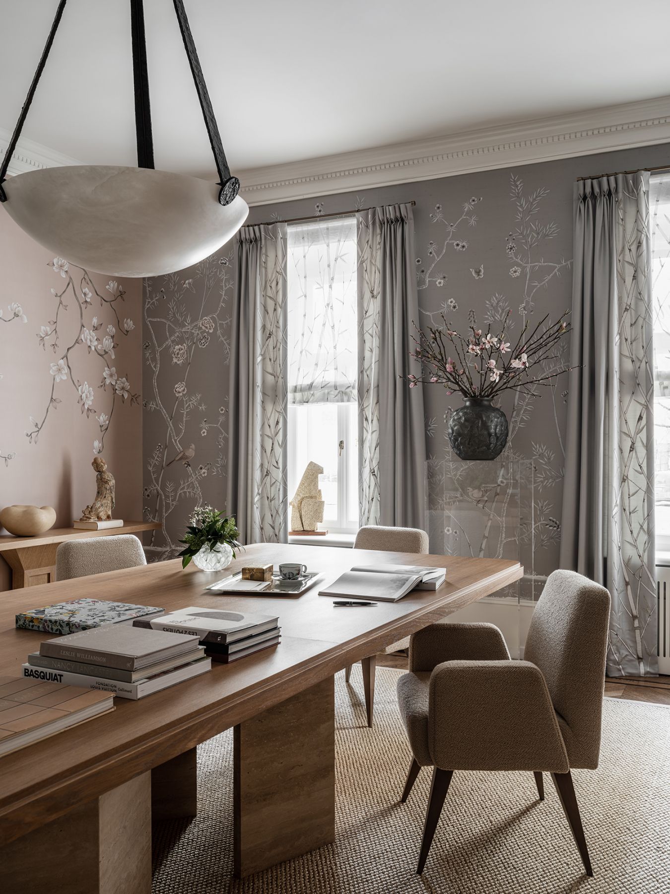 Zaria used two complementing wallpaper on different walls to create visual interest
