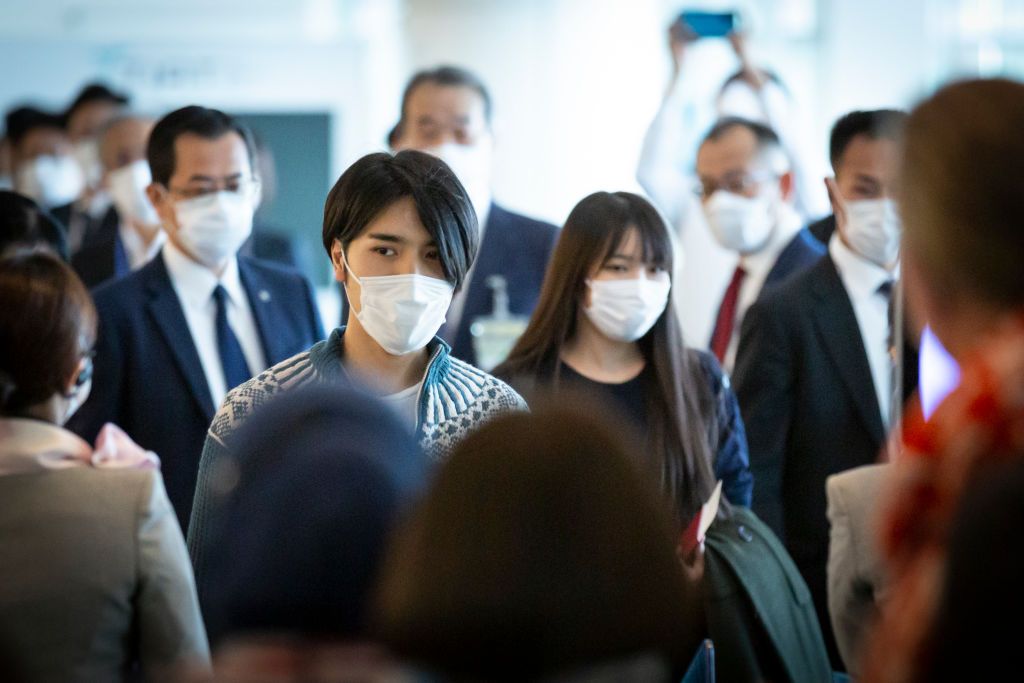 TOKYO, JAPAN - NOVEMBER 14: (LR) Kei Komuro and Mako Komuro, (formerly Princess Mako of Akishino) get on board a plane to New York at Haneda Airport on November 14, 2021 in Tokyo, Japan. (Photo by Yuichi Yamazaki/Getty Images)
