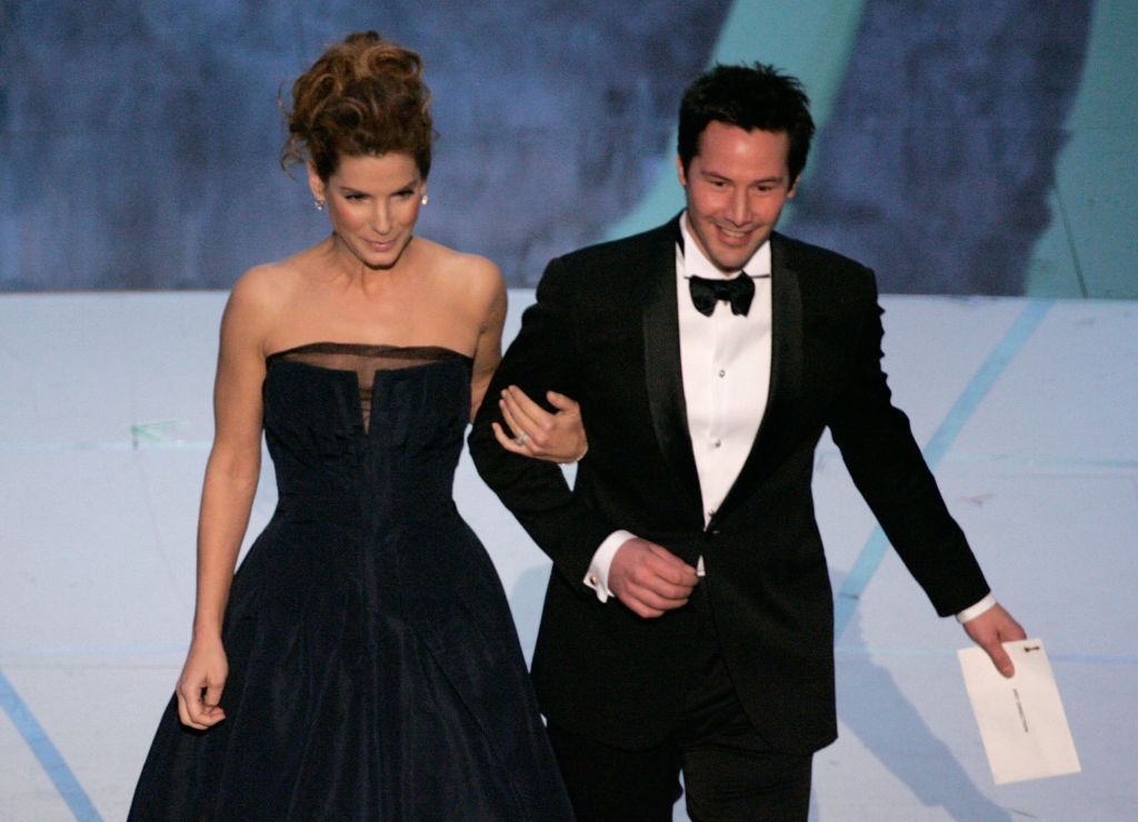 HOLLYWOOD - MARCH 05: Actors Sandra Bullock and Keanu Reeves walk onstage to present the Achievement in Art Direction award during the 78th Annual Academy Awards at the Kodak Theatre on March 5, 2006 in Hollywood, California. (Photo by Kevin Winter/Getty Images)