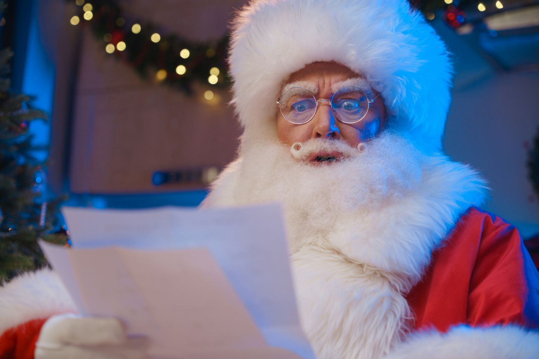 A close-up of the face of Santa Claus, who reads the letter handed to him. Santa Claus is outraged and dissatisfied, because in this letter that his assistants elves gave him a list of children who behaved badly all year. For children who behaved badly, Santa Claus has no gifts.