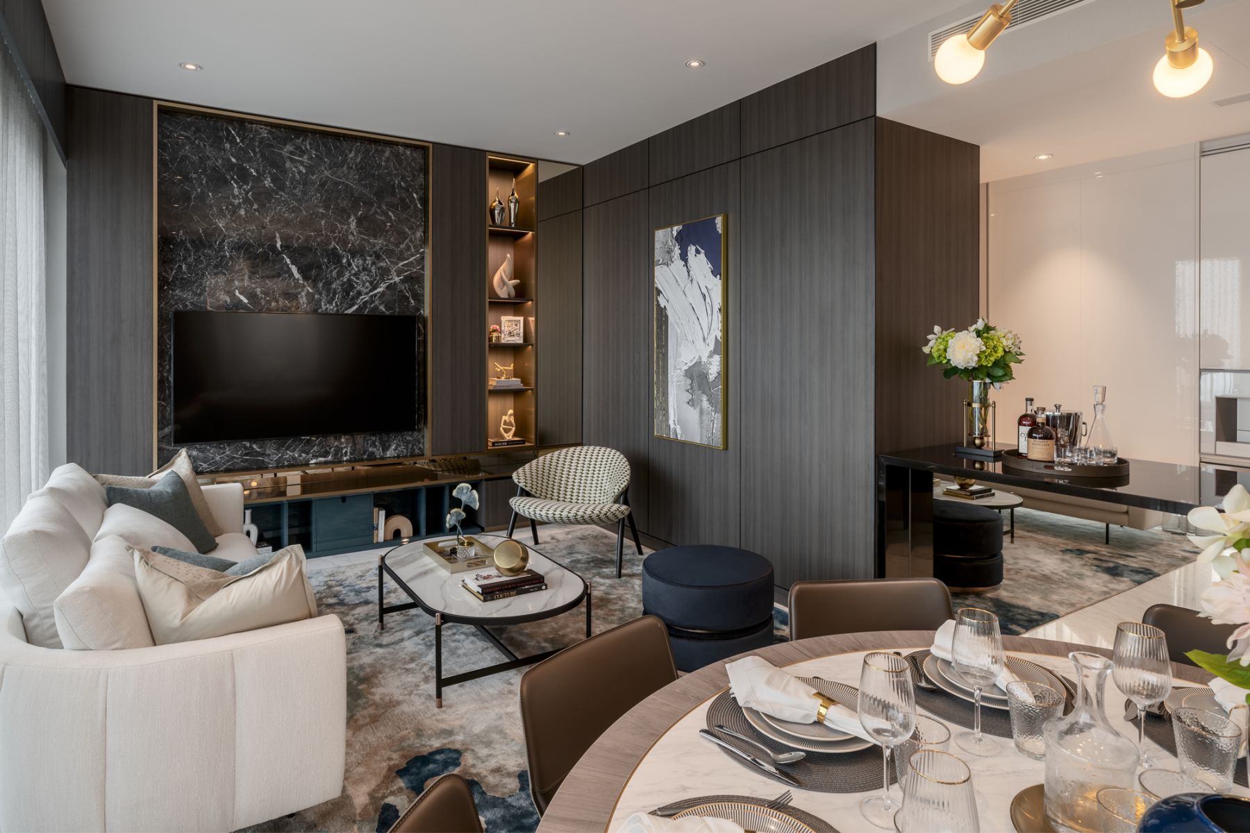 The living room features dark wood and marble alongside contrasting gilded trims