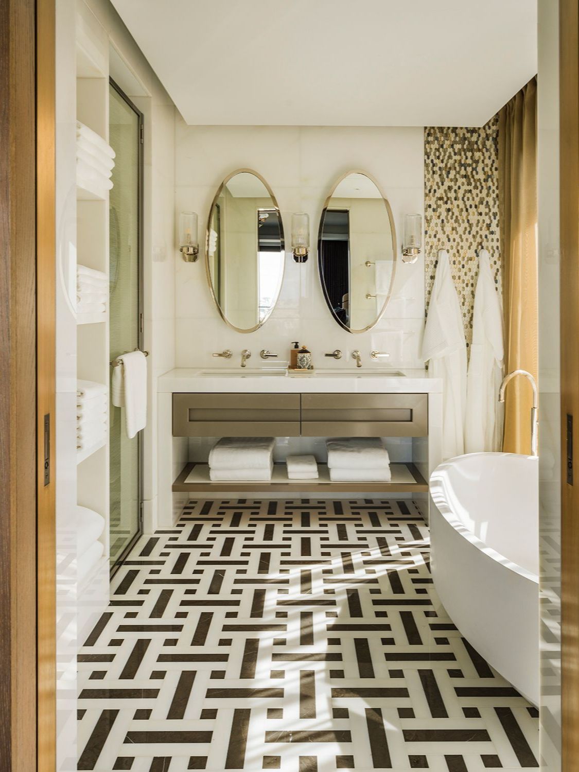 The master bathroom features bold patterned flooring for a lively touch