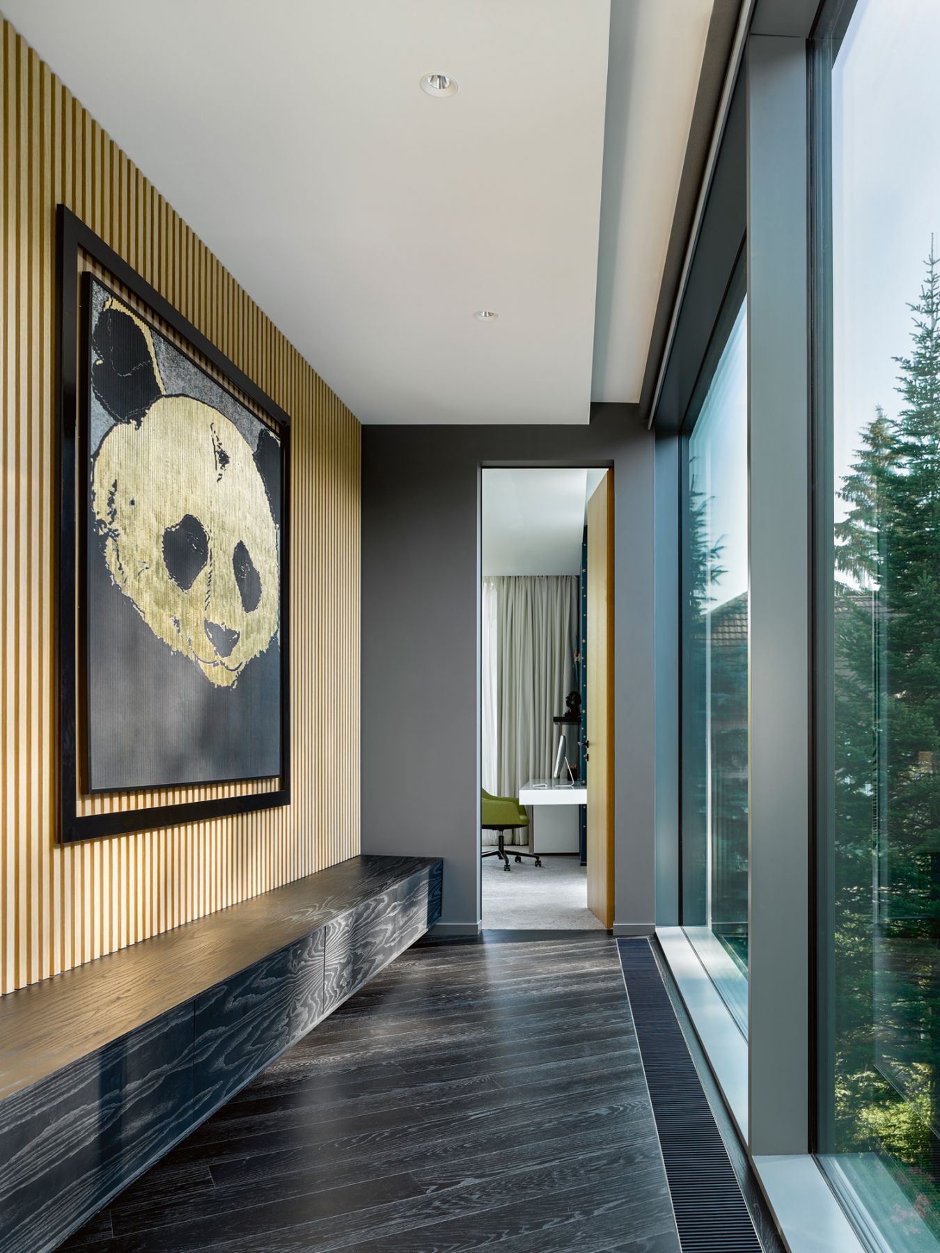 The generous use of panoramic windows brings lots of light into the home