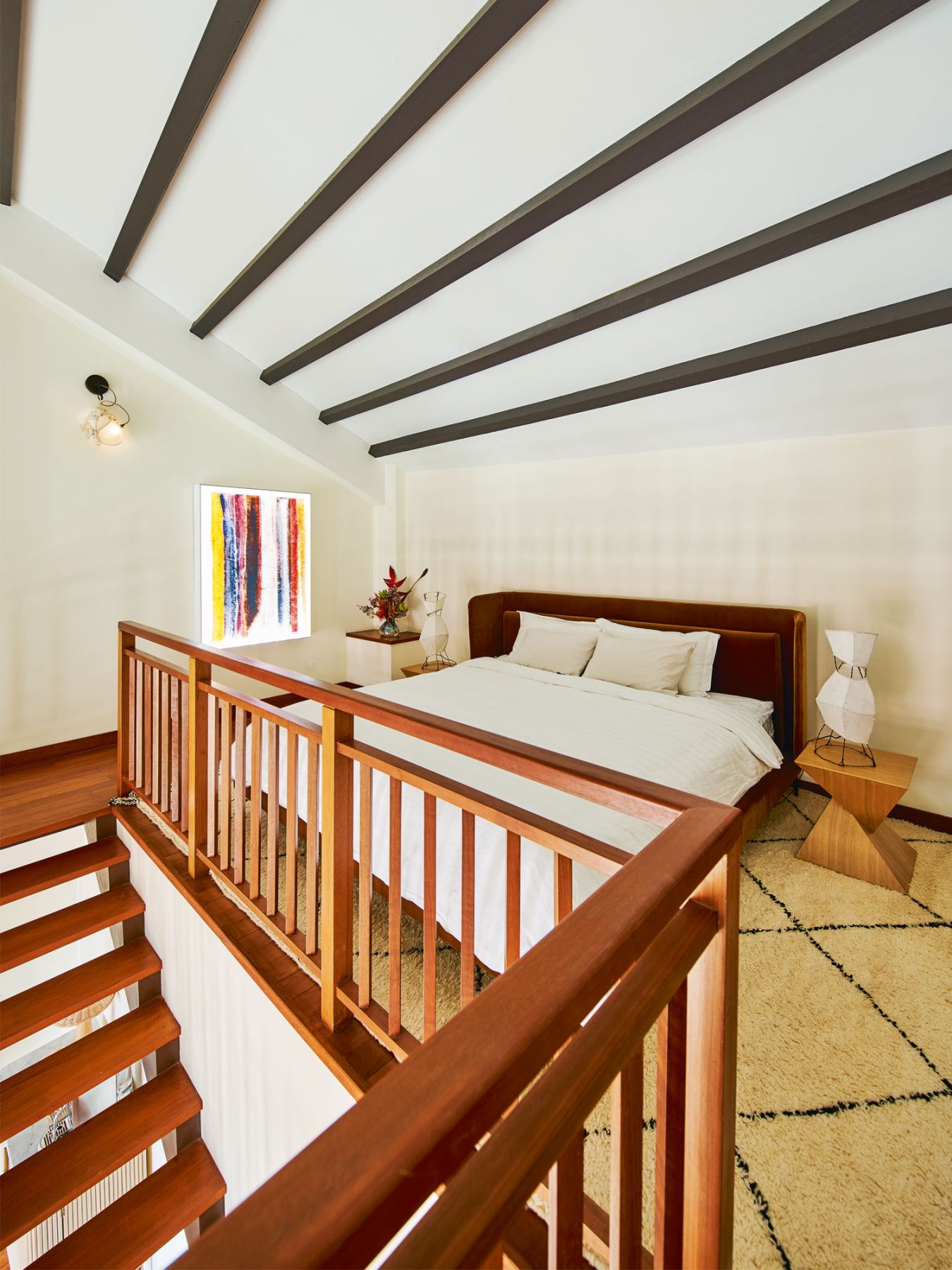 A wall-hung work by local artist Dawn Ng takes pride of place in the attic bedroom