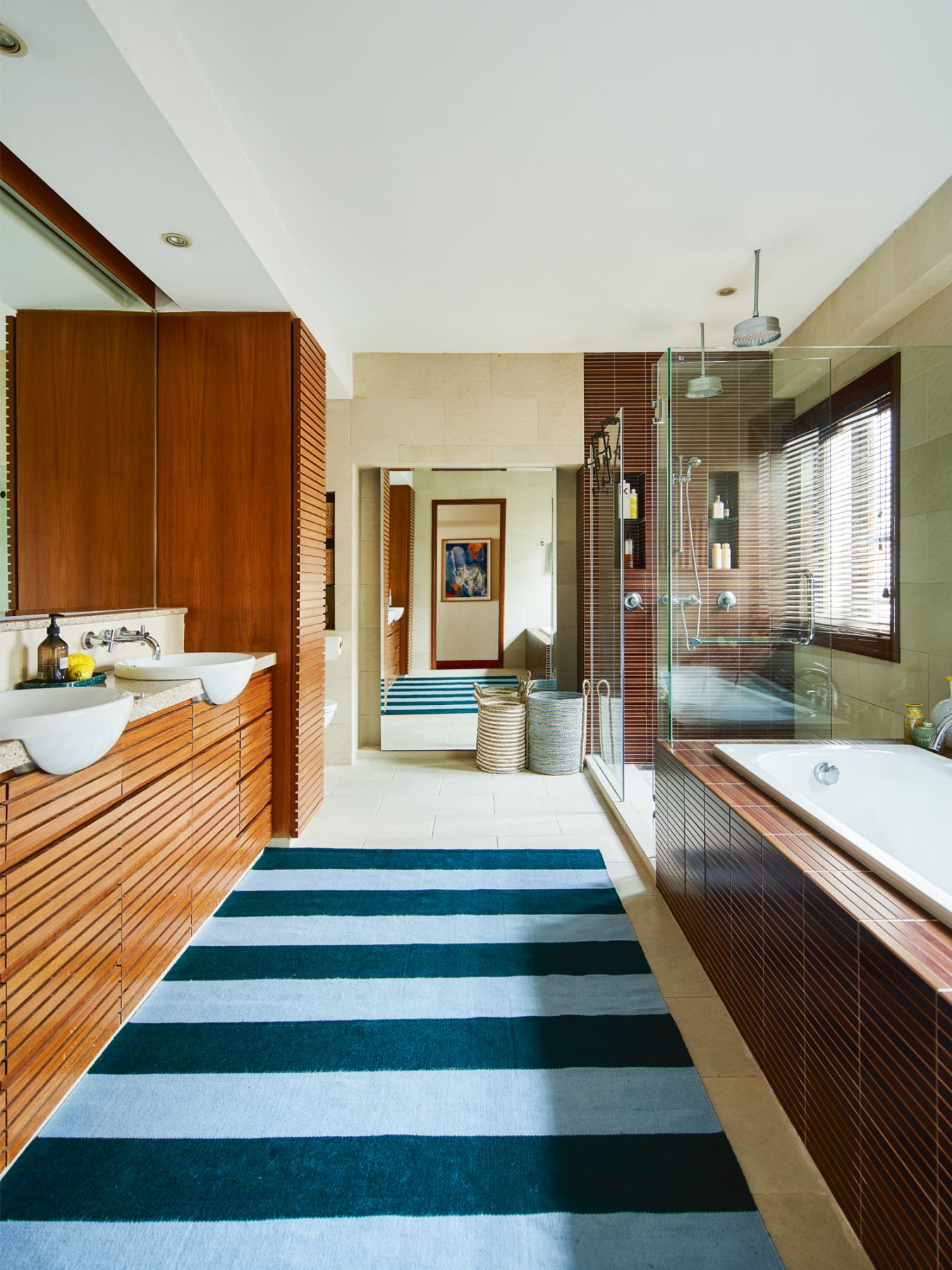 A striped rug brings visual interest to this bathroom