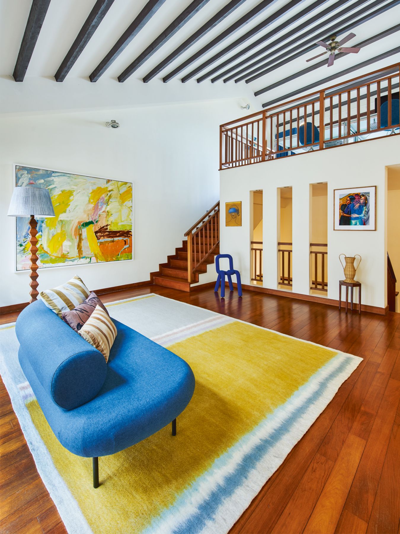 A Kvadrat rug grounds the look of this lounge area, which also features the Bold chair from Moustache Paris and a sofa from Proof Living, and leads to a home office on the mezzanine