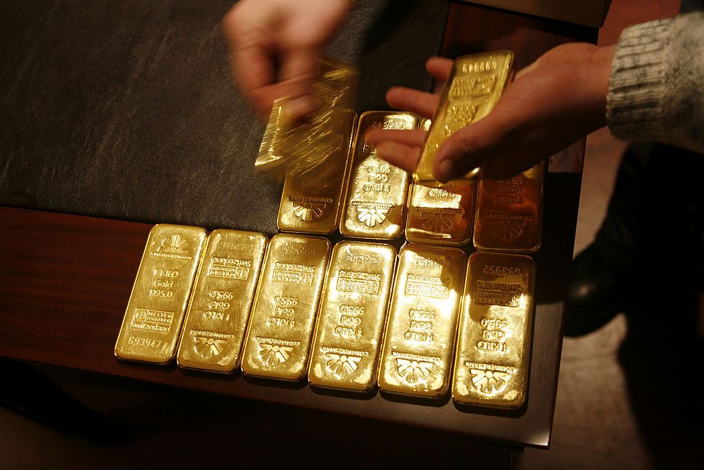 ISTANBUL, TURKEY - MARCH 16: Plates of gold are examined in the office of the gold trade company AYCAN in the Grand Bazaar on March 16, 2005 in Istanbul, Turkey. Traders in the Grand Bazaar have developed a community of traders that trade gold on streets corners of the grand bazaar. Trust and security is what holds this community together and made the Grand Bazaar a traditional place for gold trading. (Photo by Yoray Liberman/Getty Images)