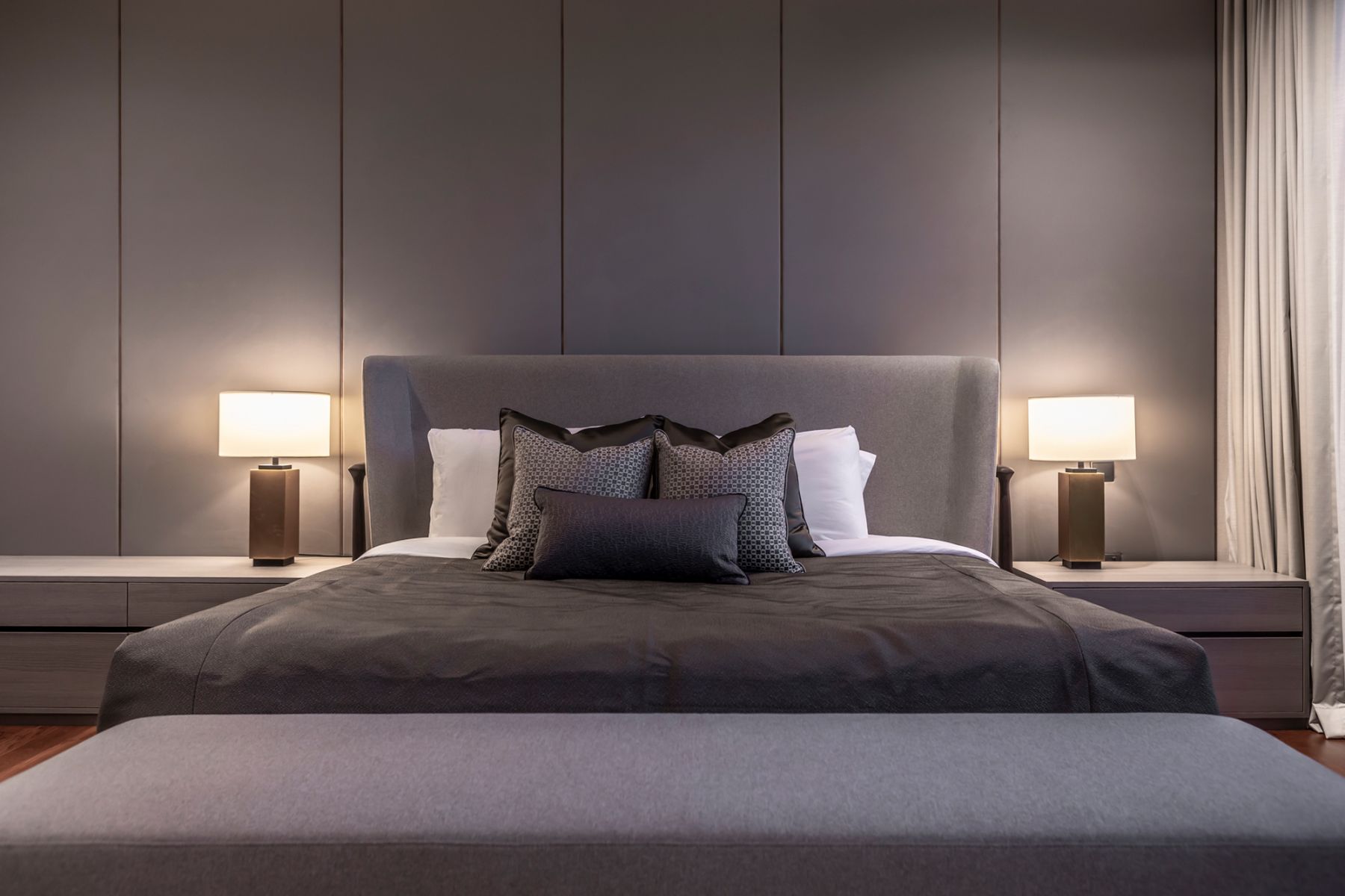 A dark colour palette lends a cosy atmosphere to the master bedroom