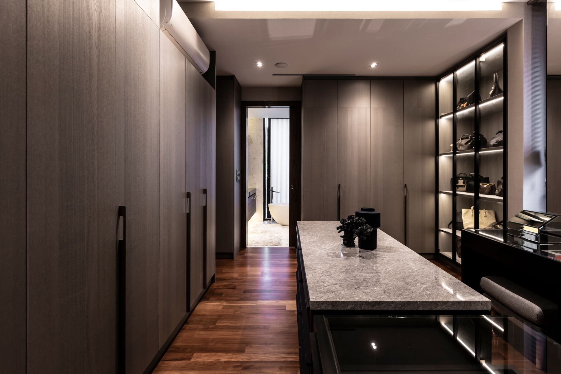 The walk-in wardrobe houses the wife's extensive collection of clothes, shoes and bags