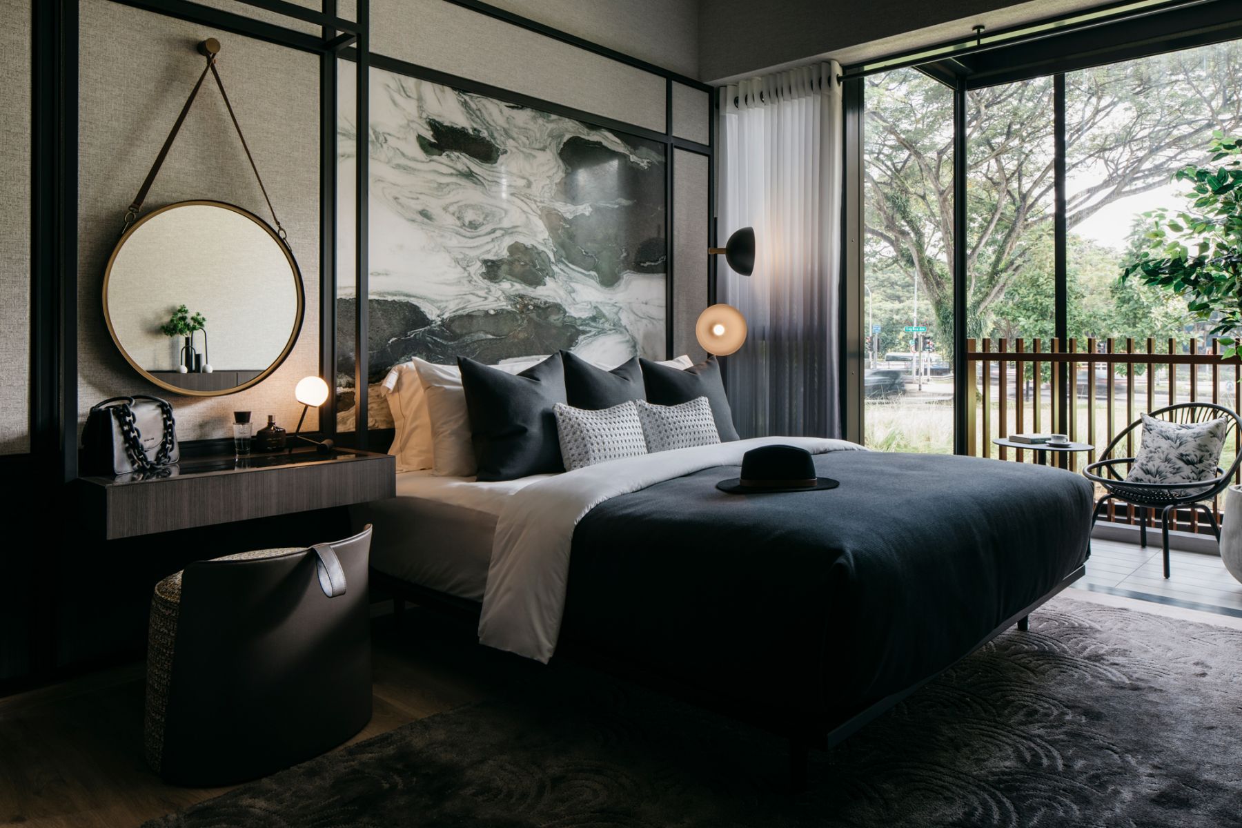 A cosy balcony area offering a breath of fresh air can be found within this master bedroom