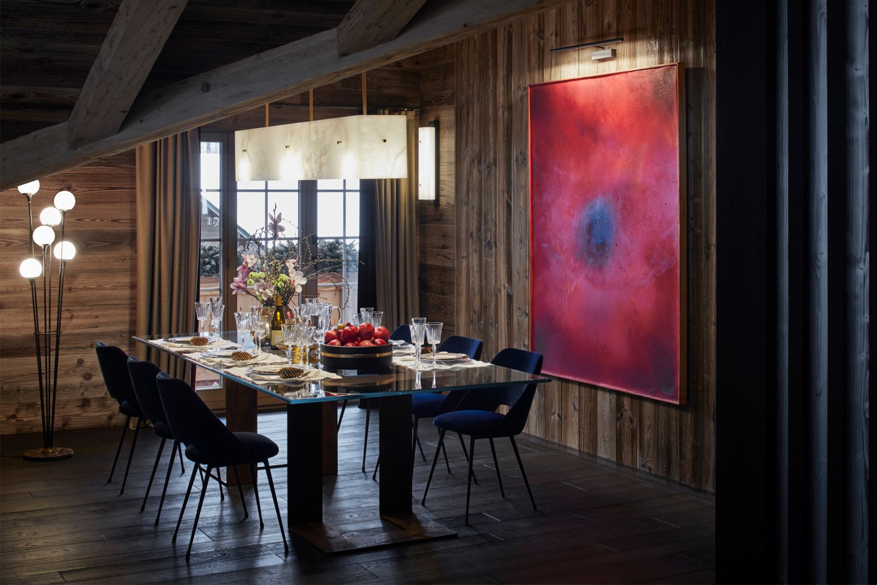 A vibrant artwork adds colour and energy in this dining room with rustic charm