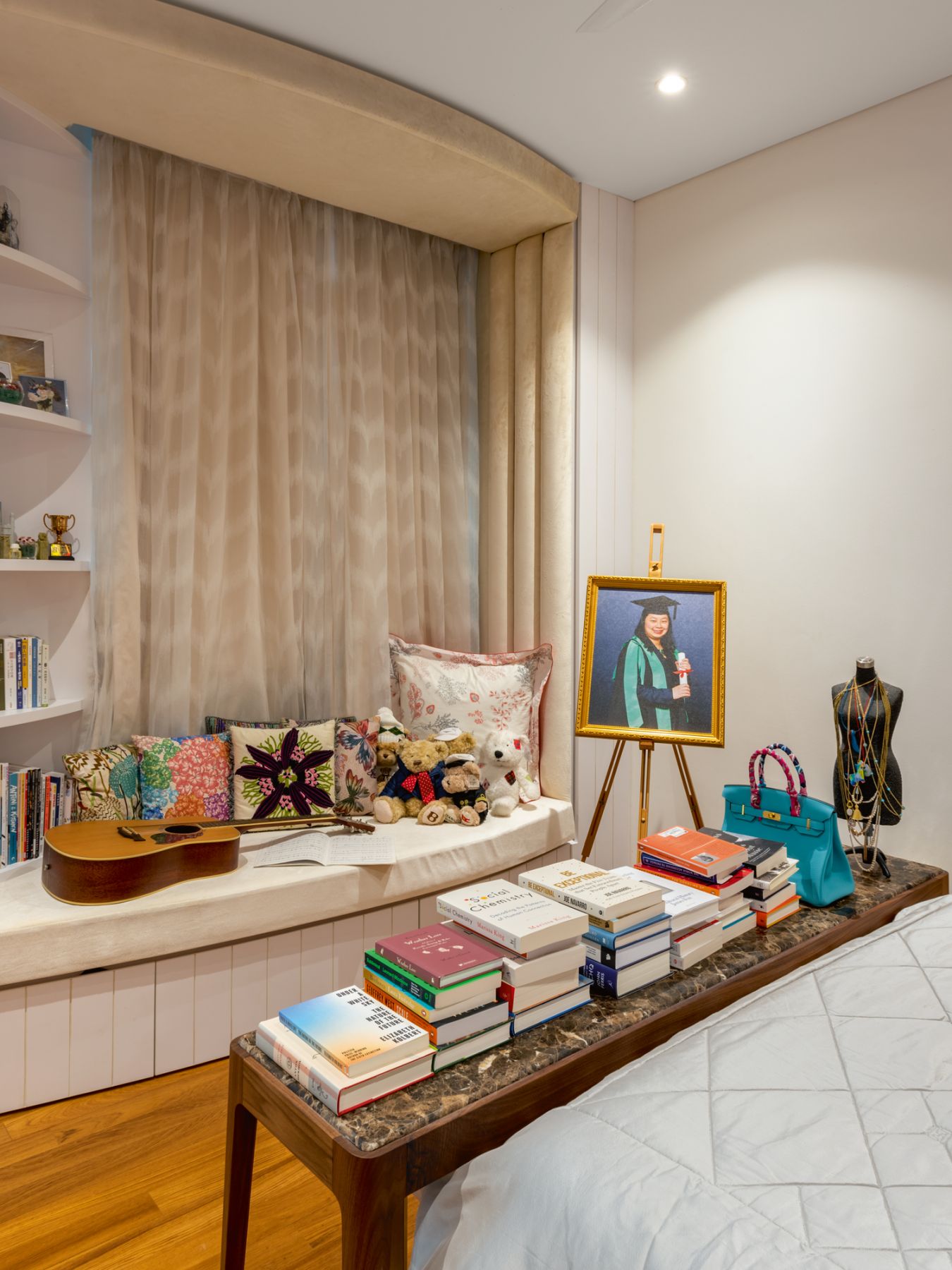 A long bench in the daughter's bedroom is where she can read and play music