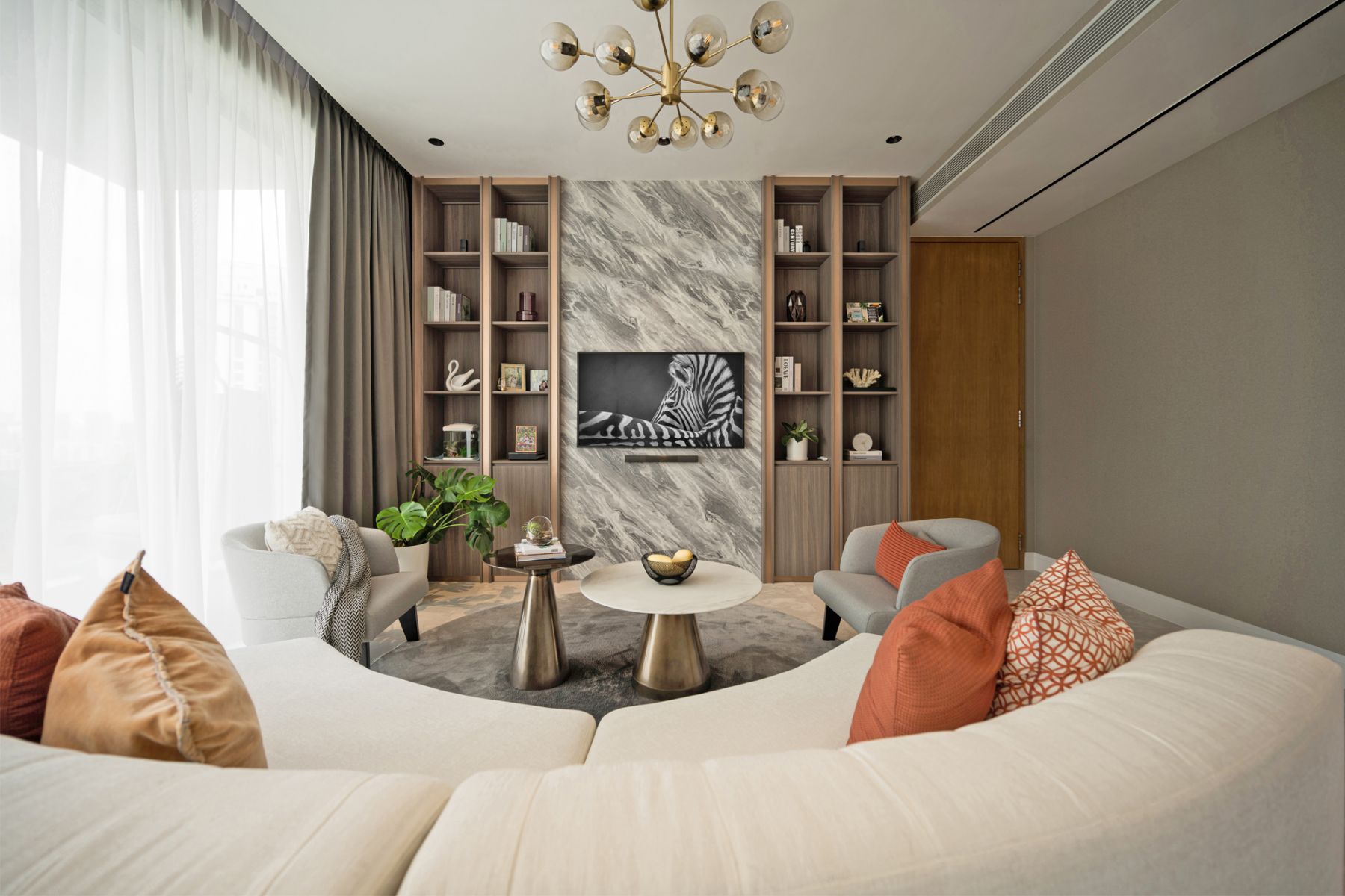 The living room boasts a TV feature wall that adds refined elegance to the space