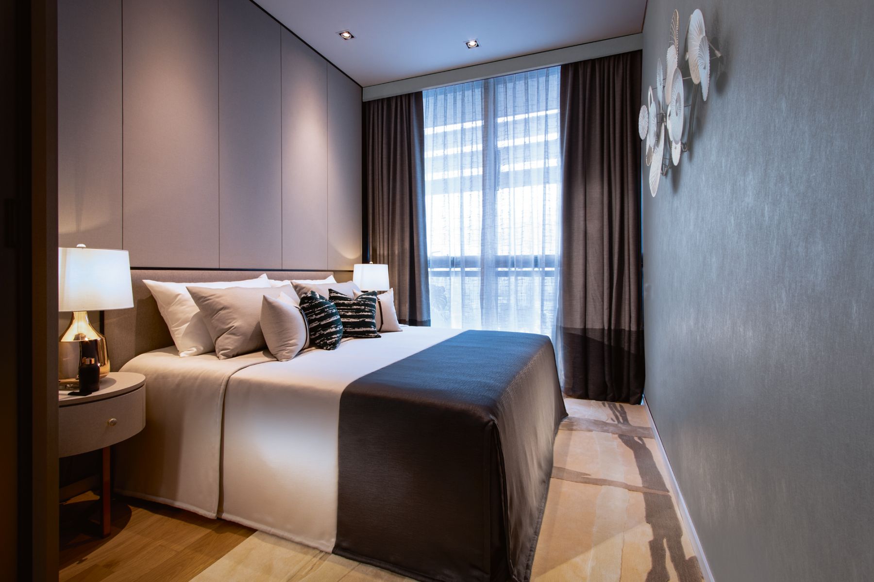 Textured wallpaper and a wall-hung art piece bring a new dimension to this bedroom