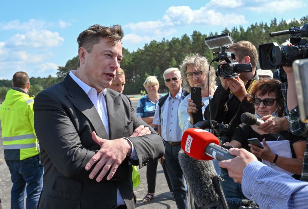 03 September 2020, Brandenburg, GrÃ¼nheide: Elon Musk, head of Tesla, stands on the construction site of the Tesla Giga-Factory and talks to journalists. In GrÃ¼nheide near Berlin, a maximum of 500,000 vehicles per year are to roll off the assembly line from July 2021 - and according to the car manufacturer's plans, the maximum is to be reached as quickly as possible. Photo: Patrick Pleul/dpa-Zentralbild/ZB (Photo by Patrick Pleul/picture alliance via Getty Images)