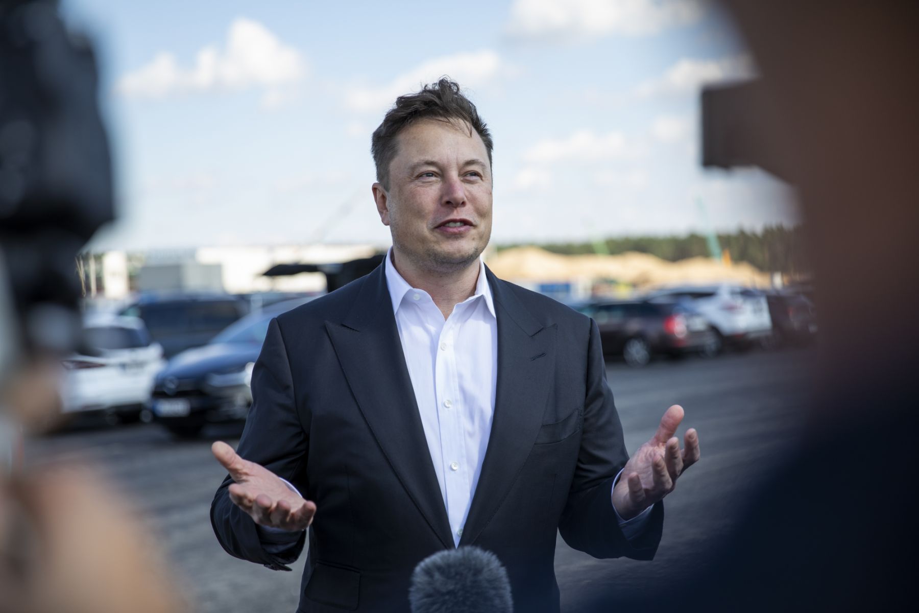 GRUENHEIDE, GERMANY - SEPTEMBER 03: Tesla head Elon Musk talks to the press as he arrives to to have a look at the construction site of the new Tesla Gigafactory near Berlin on September 03, 2020 near Gruenheide, Germany. Musk is currently in Germany where he met with vaccine maker CureVac on Tuesday, with which Tesla has a cooperation to build devices for producing RNA vaccines, as well as German Economy Minister Peter Altmaier yesterday. (Photo by Maja Hitij/Getty Images)