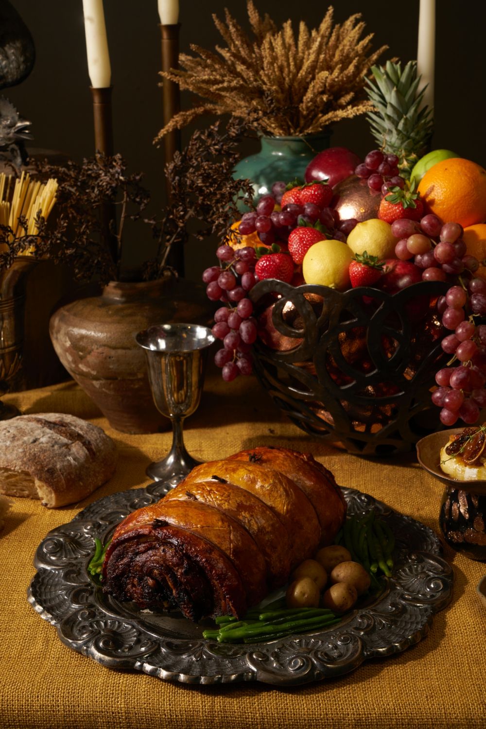 A perfectly crispy porchetta by Belly Best on a silver platter from W/17 and beautiful fresh fruits from Crate 2 Plate | Photo by Sonny Thakur