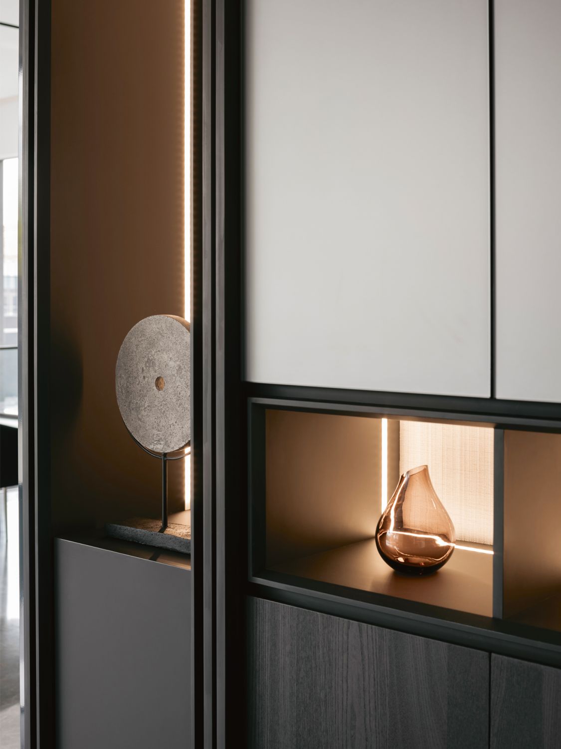 The display cabinets are custom made and clad in a dark stained timber finish