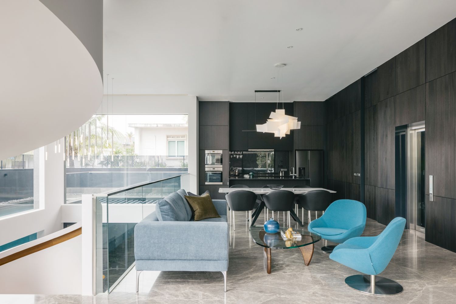 A Foscarini Big Bang lamp by Vicente Garcia Jimenez and Enrico Franzolini floats above the open-plan living and dining area