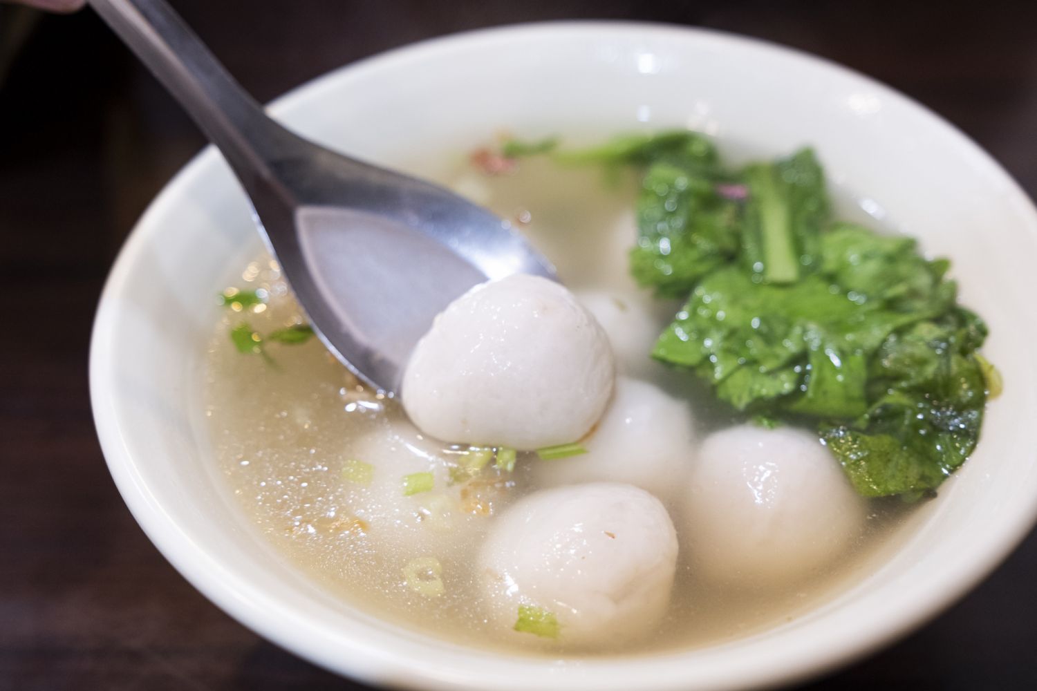 Savory tangyuanâGlutinous Rice balls stuffed with ground pork in soup. Tang yuan, yuan xiao, Chinese traditional food rice dumplings in red and white for lunar new year, winter festival, close up.