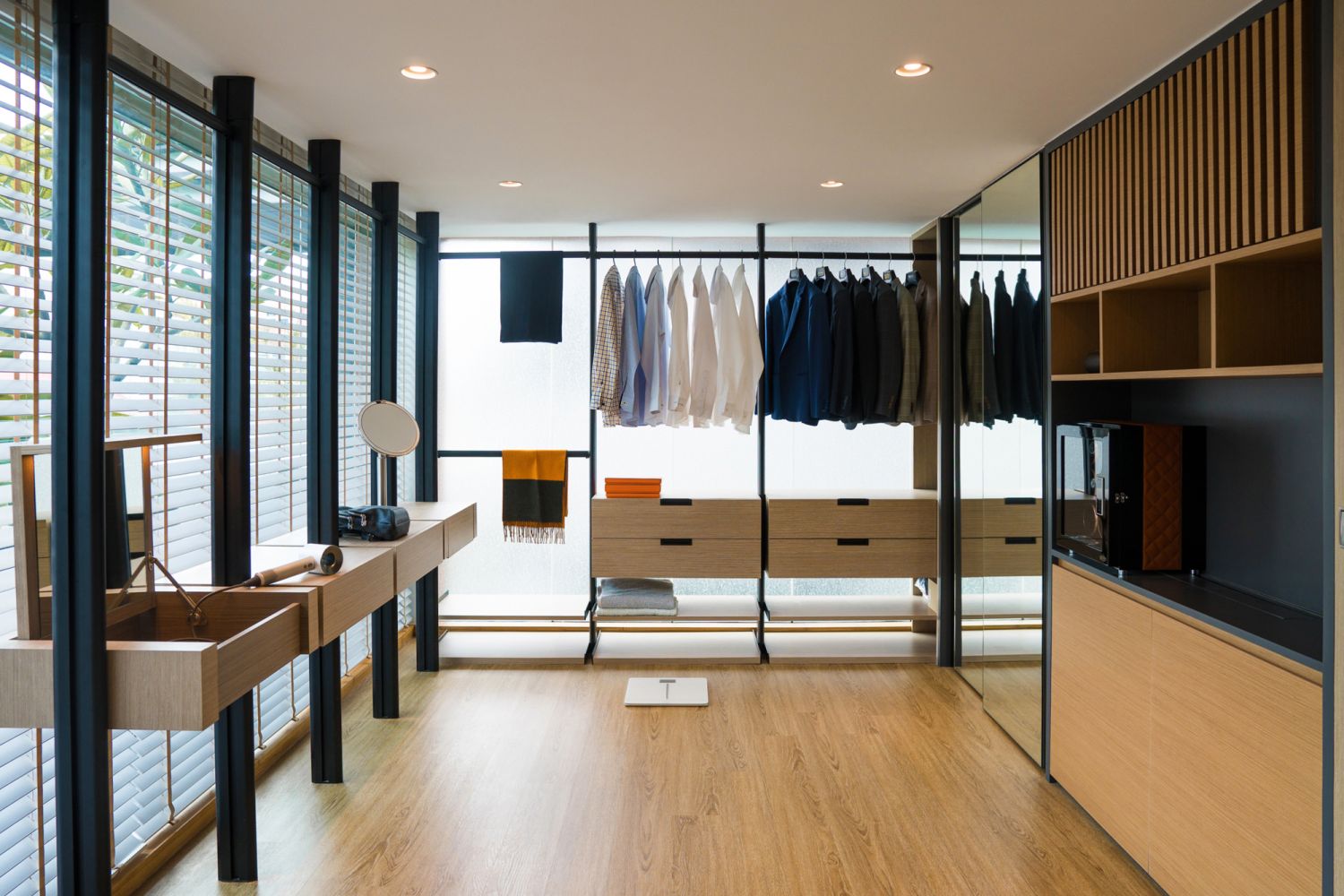 The walk-in wardrobe features a clean, contemporary style that is consistent with the rest of the abode
