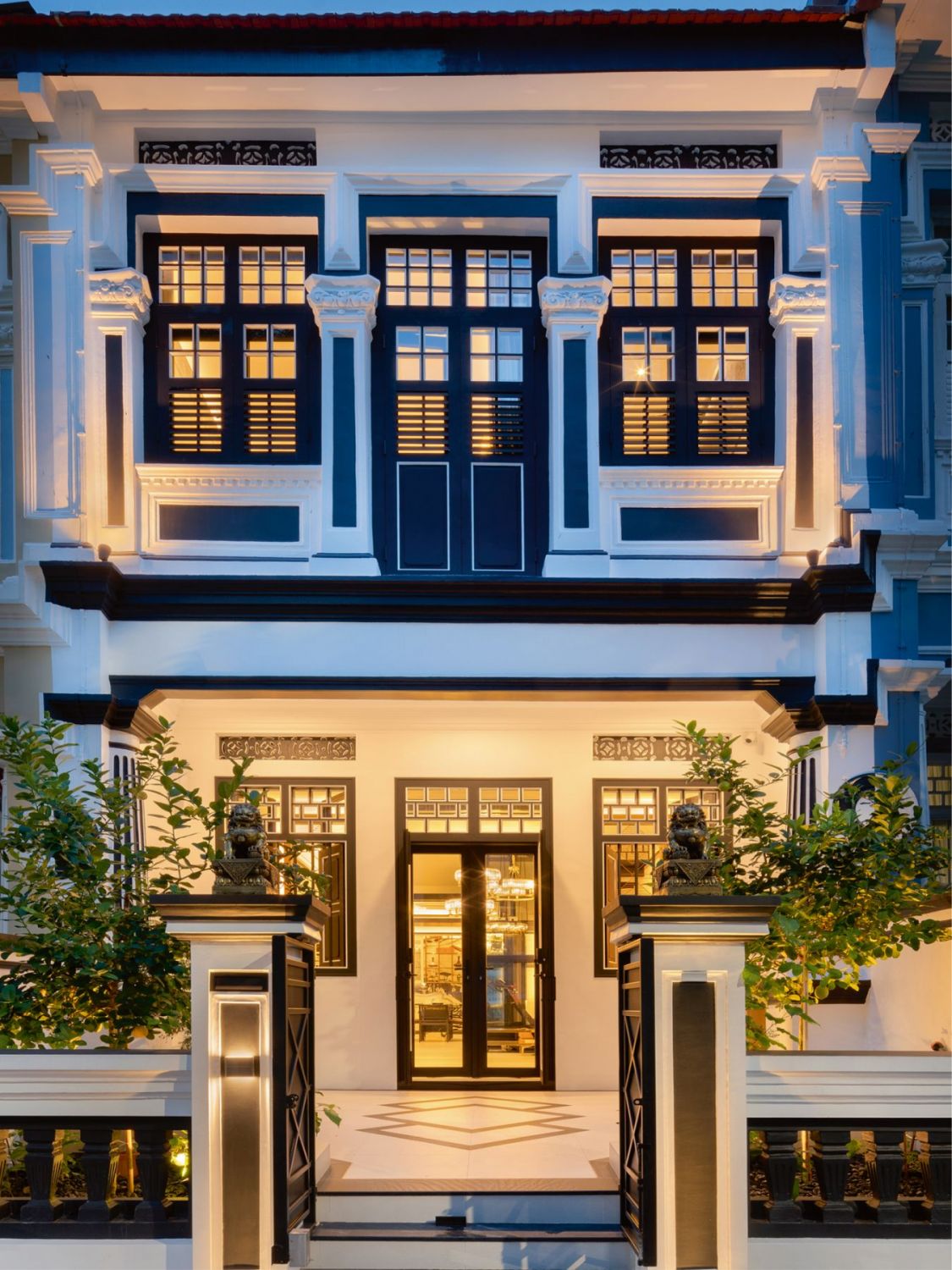 The striking facade of the shophouse unit features glass and timber windows that offer a tantalising peek at its beautiful interior (Image: Design Intervention)