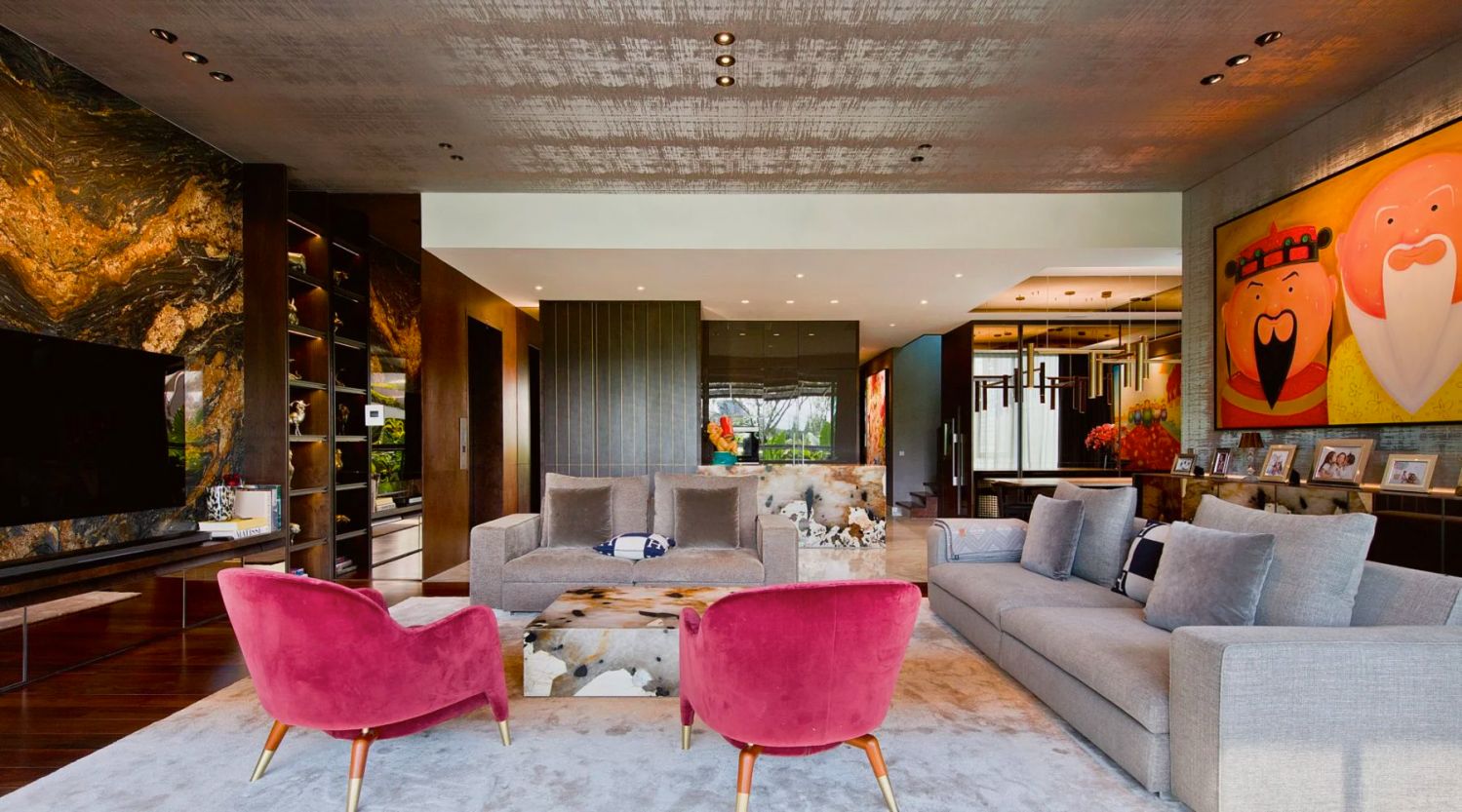 The light-filled living room features the Fu Lu Shou painting by Shen Jing Dong, furnishings from Molteni&C and a striking Magma Gold granite feature wall behind the TV