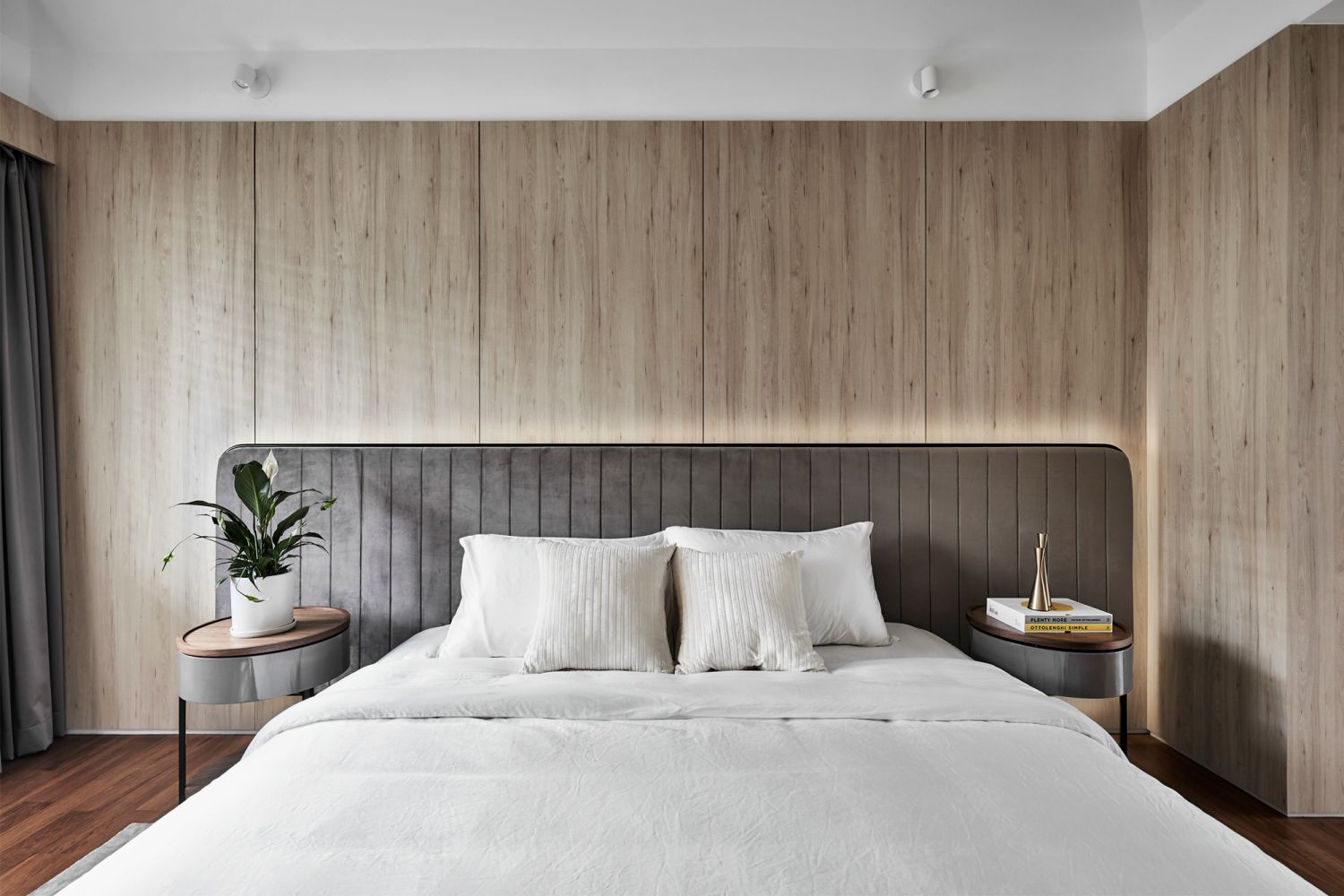 The master bedroom emits a relaxing atmosphere with wood panels that offer warmth