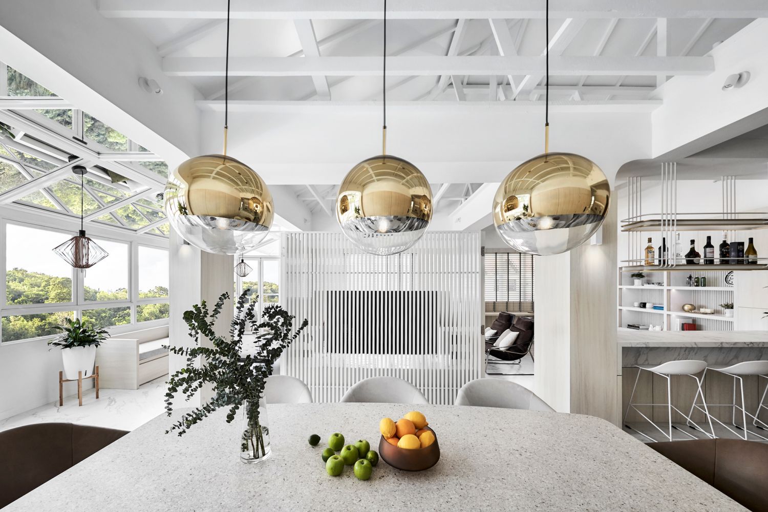 The pendant lighting hanging above the dining table adds a touch of luxe to the area