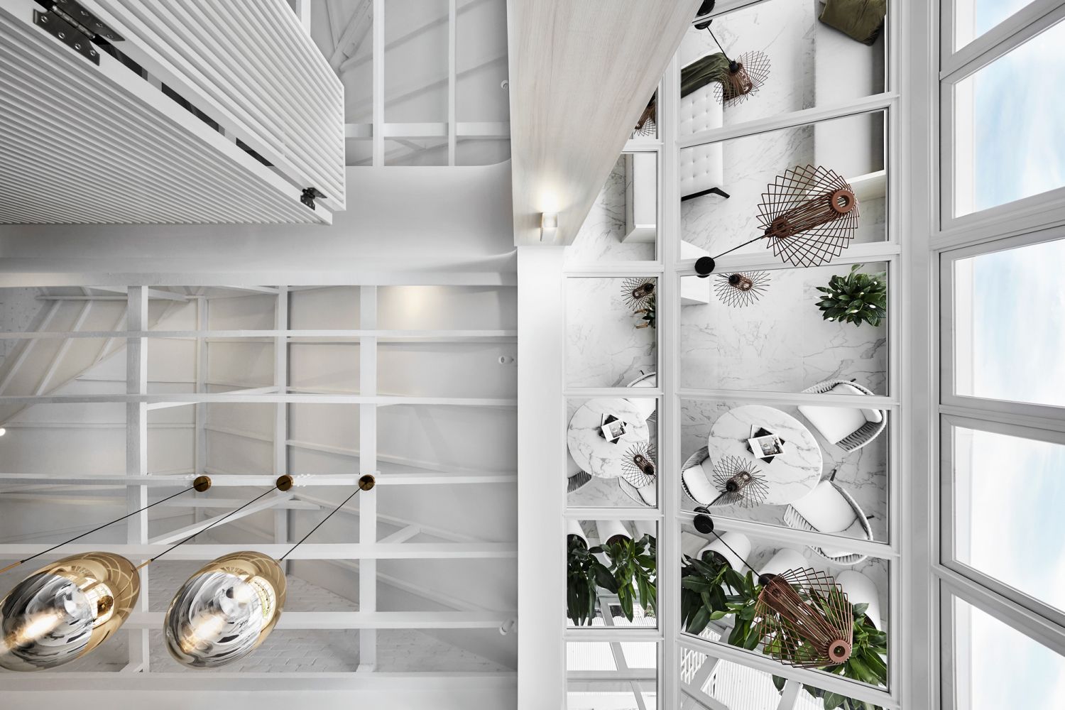 The ceiling view of the solarium-like area, which features aluminium frames and mirrored infill panels